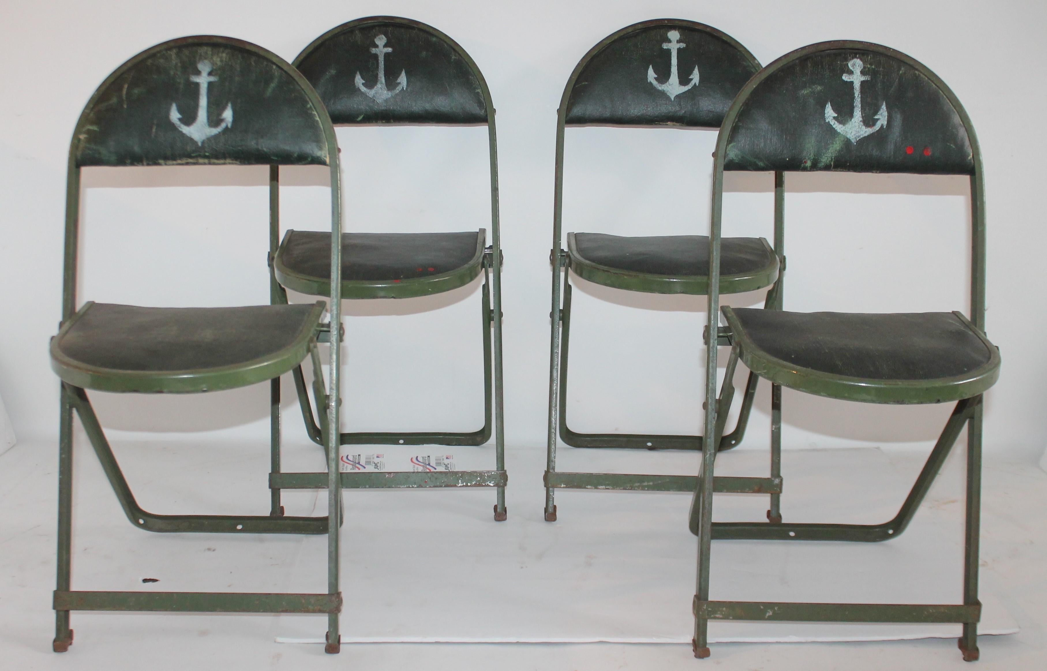 This very cool child's original green painted folding table and folding padded chairs are in very good condition. The chairs have the original oil cloth seats and backs on every chair. They are all painted green with little white painted anchor's on