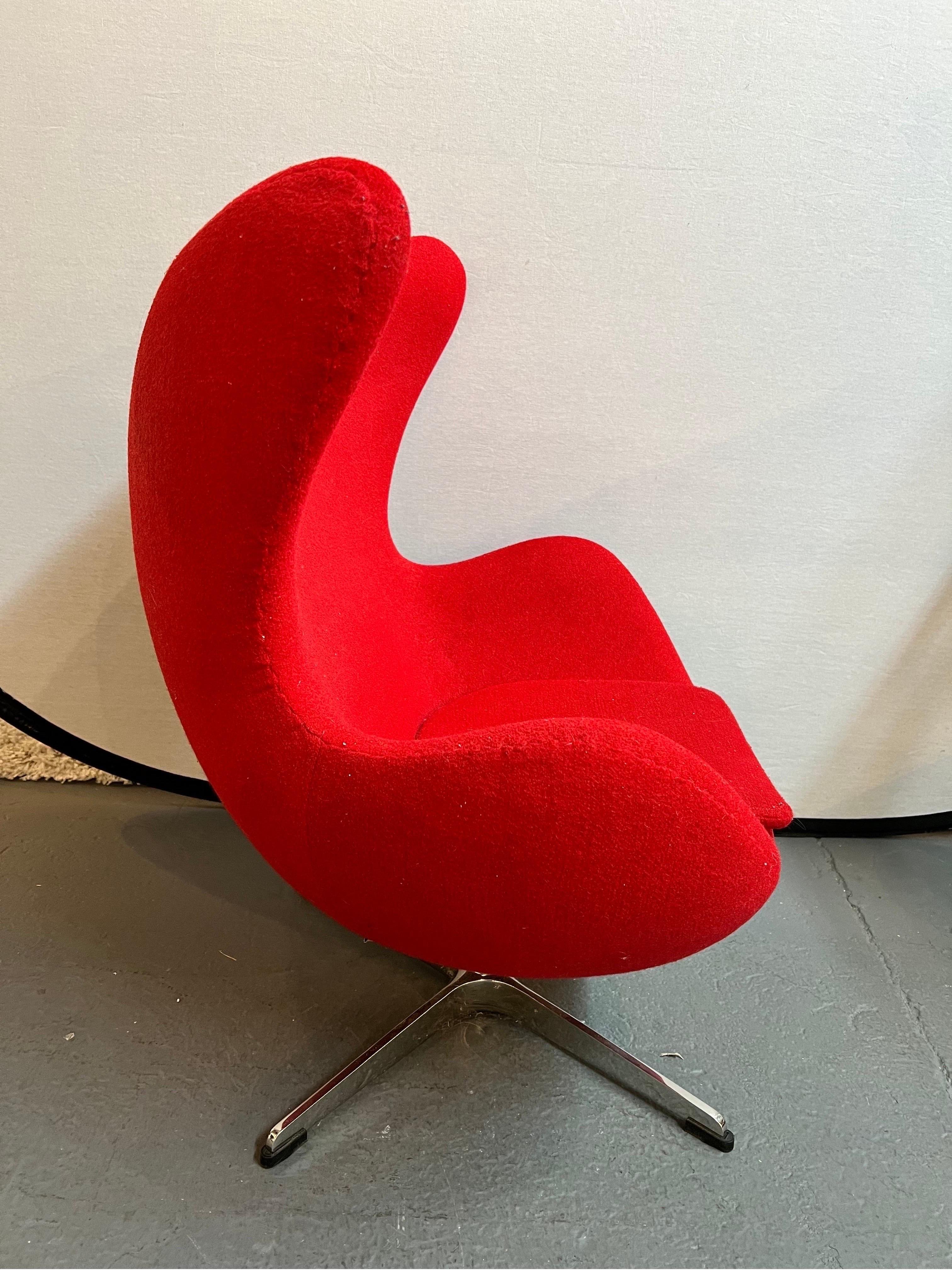 Unusual Egg Chair reproduction that is done with scale for a child, not the dimensions which are above. Upholstered in a red wool and supported by an aluminum base. No hallmarks at bottom. Age appropriate wear.