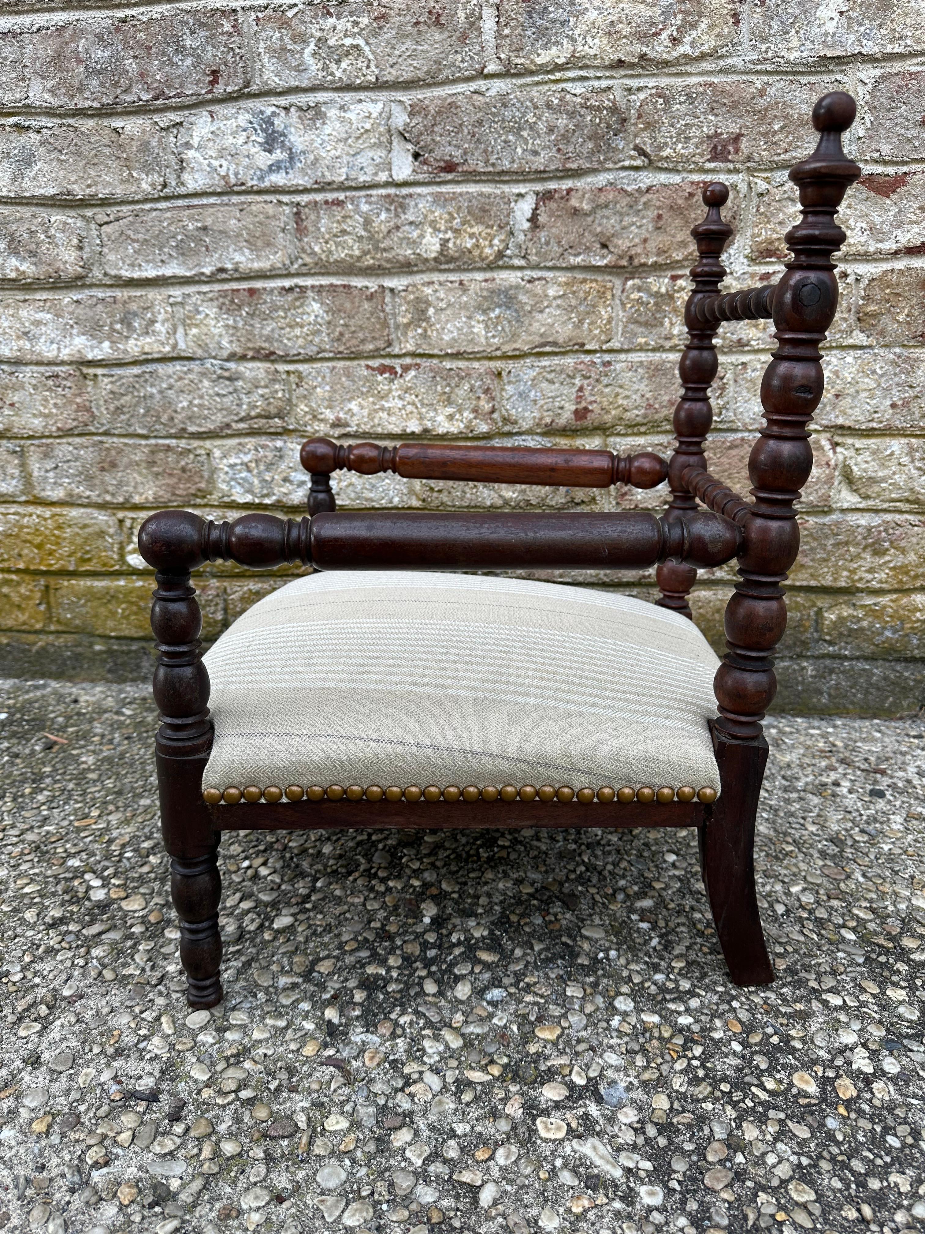 Lovely child's carved bobbin armchair newly reupholstered with striped linen and brass nail heads.....
