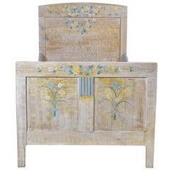 Antique Child's Bed with Blue & Yellow Flowers over White Background, Europe, circa 1920