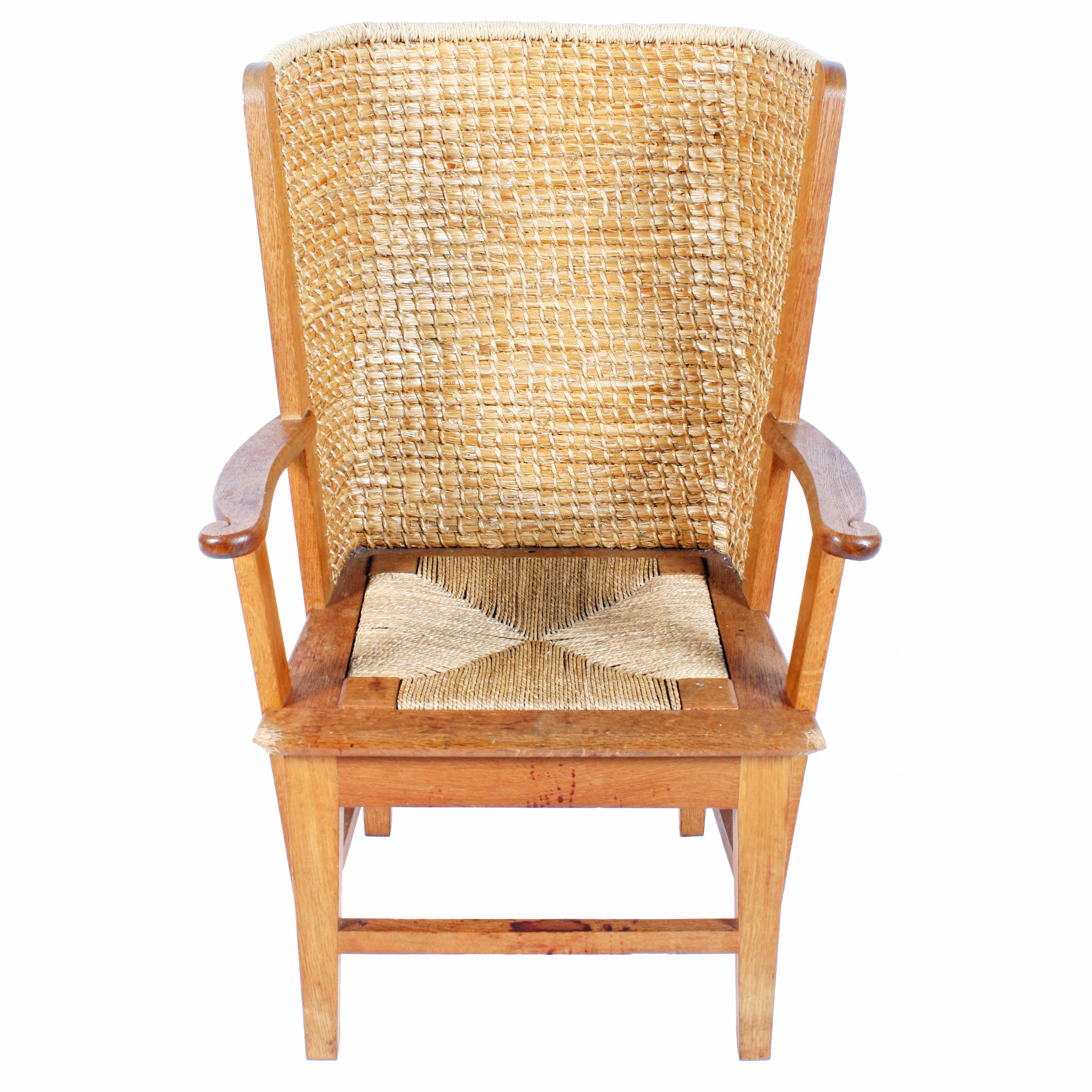 A late 20th century oak framed child's Orkney chair.

The back is constructed from black oat straw and bent grass, bound together with cord made from twisted bent grass.

The back is almost straight before it curves smoothly out to create a
