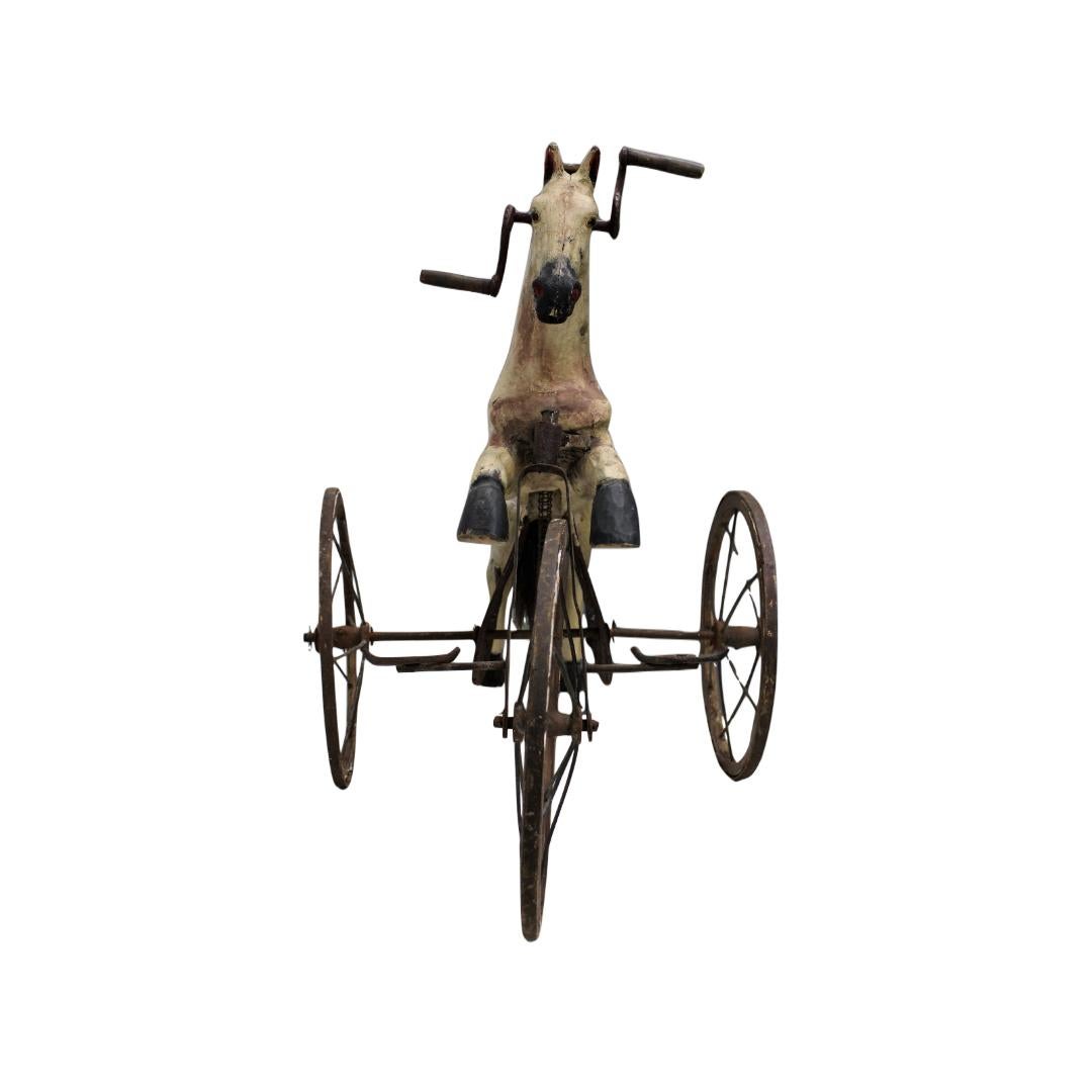 C. xIXe siècle

Tricycle en bois peint pour enfant.