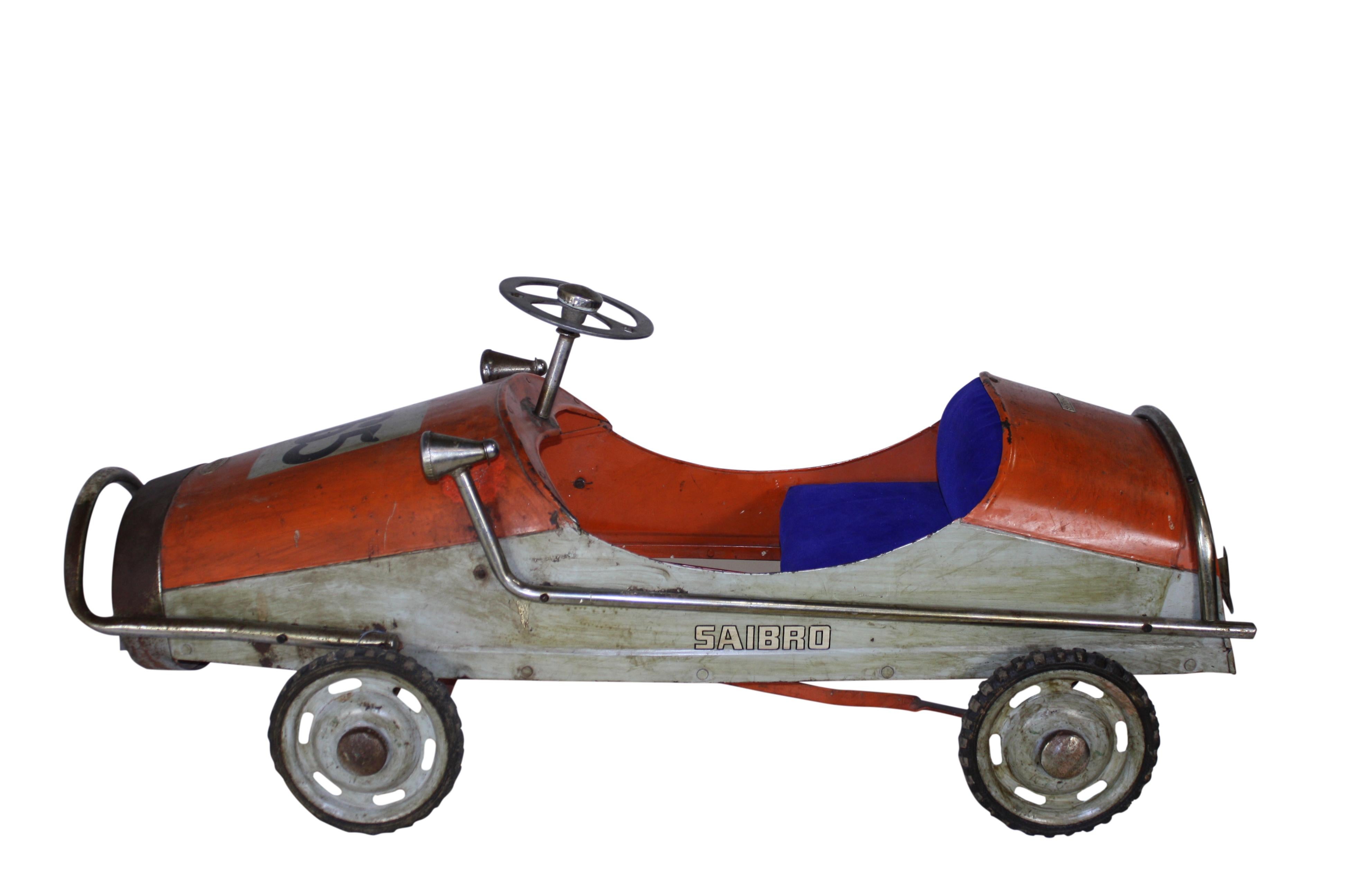 Sleek and sporty, this mid-20th century pedal car by Saibro features a mesh grille, padded seat, rubber tires, and proudly wears #165.

 