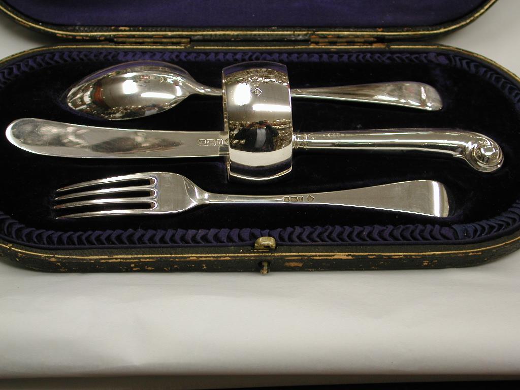 Child's silver knife, fork and spoon set with matching napkin ring, dated 1905
Assayed in Sheffield, made by Martin Hall & Co.
Knife and fork are in the rattail pattern with a pistol grip knife.
In original fitted box.
