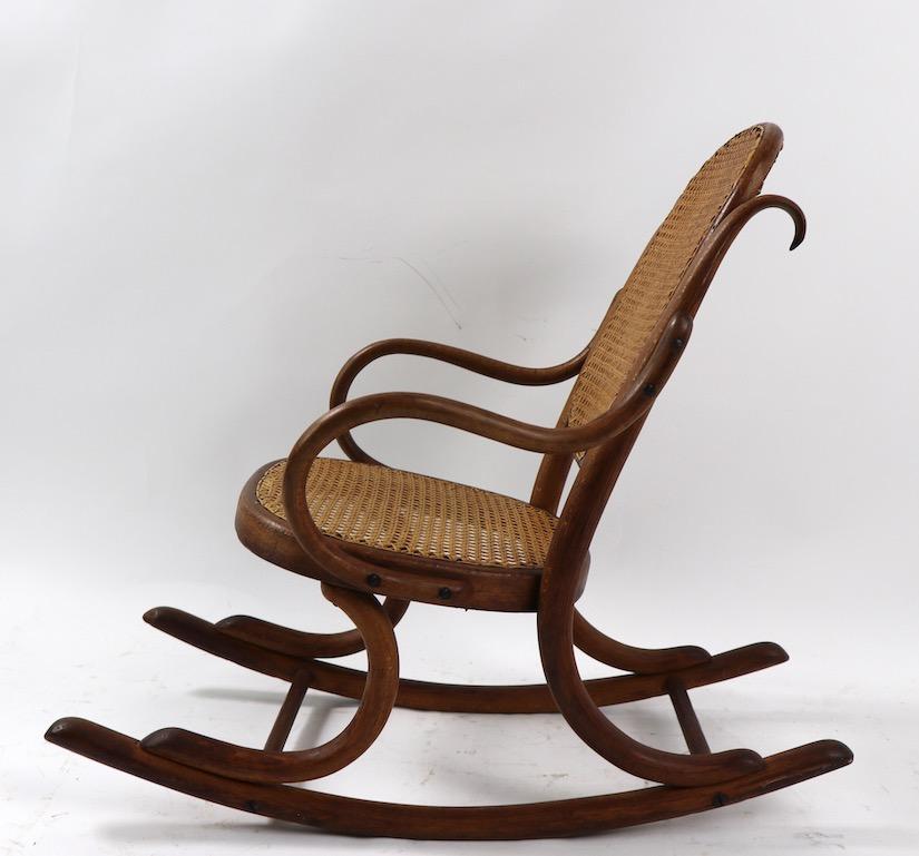 Stylish child’s bentwood rocking chair attached to Thonet. This example is in very good original condition showing only light wear normal and consistent with age.
Measures: Total H 24.5 x arm H 15.5 x seat H 11.5 inches.