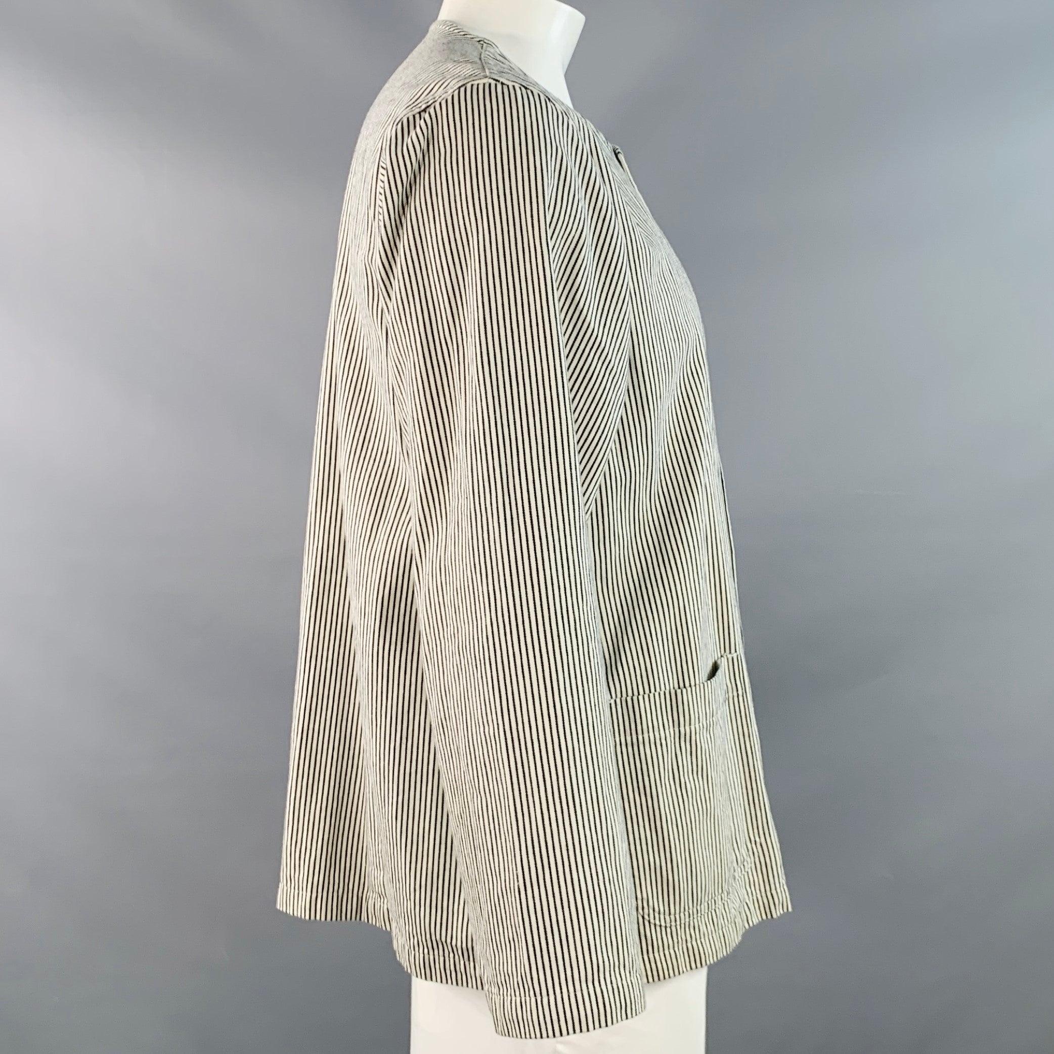 CHIMALA jacket
in a white and black cotton woven fabric featuring a stripe pattern, collarless style, two patch pockets, and snap closure. Made in Japan.Excellent Pre-Owned Condition. 

Marked:   L 

Measurements: 
 
Shoulder: 17.5 inches Chest: 46