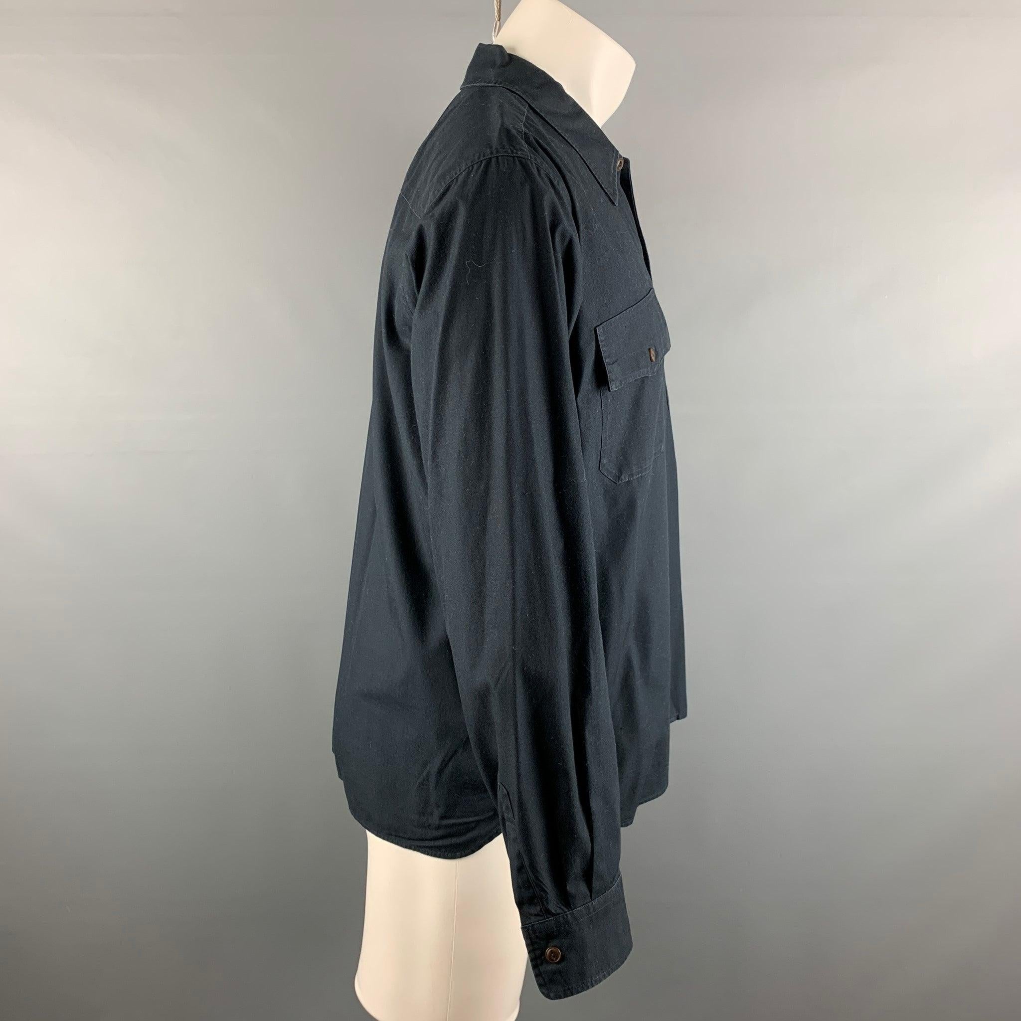 CHIMALA long sleeve shirt comes in a black cotton featuring a spread collar, patch pockets, and a button up closure. Made in Japan.Very Good Pre-Owned Condition. 

Marked:   M 

Measurements: 
 
Shoulder: 19 inches Chest: 46 inches Sleeve: 24 inches