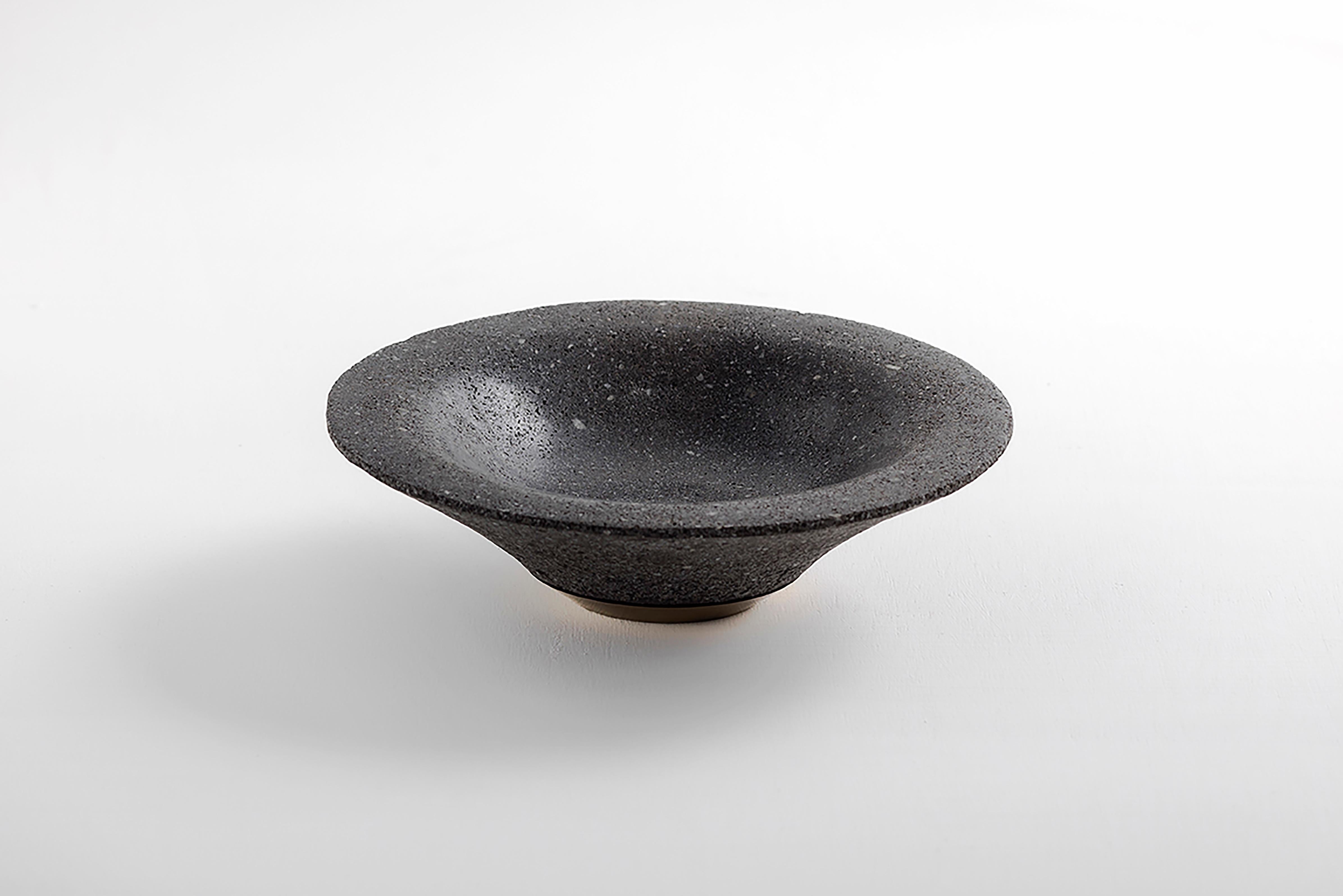Decorative volcanic stone hand-carved bowl from Chimborazo volcano, with lathed bronze base.

Drawing inspiration from the sacral and baroque motifs of Quito, as well as Ecuador’s highest and dormant volcano, these bowls are meticulously hand-carved