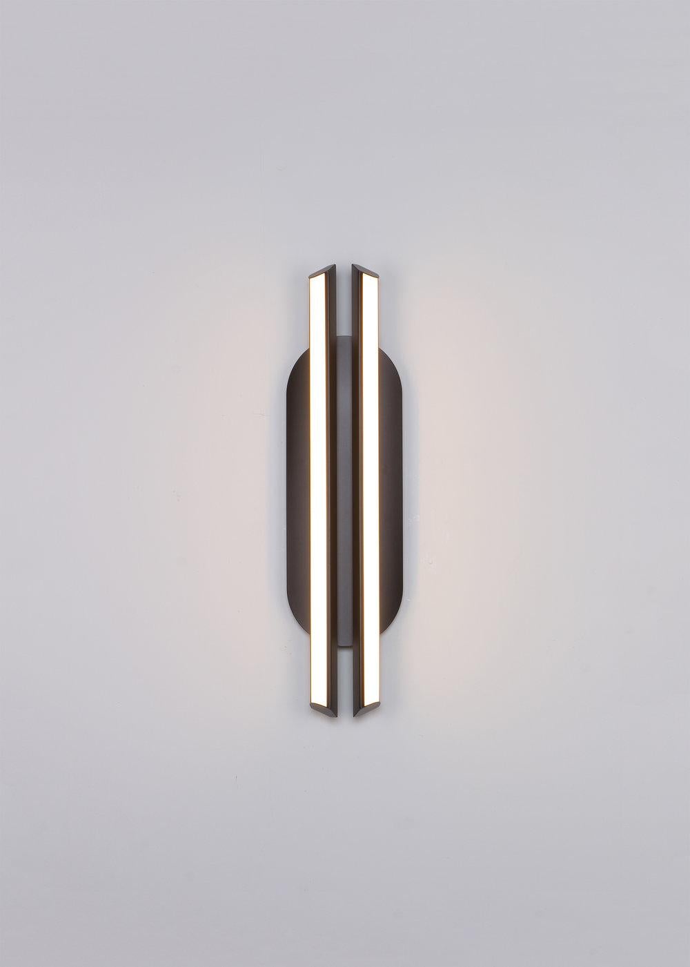 Chime Capsule sconce balances two parallel bars of soft light over a gently curved backplate. The Chime series was inspired by the harmonious sound of resonating bells. Chime Capsule provides ample light into a room while also washing light across a