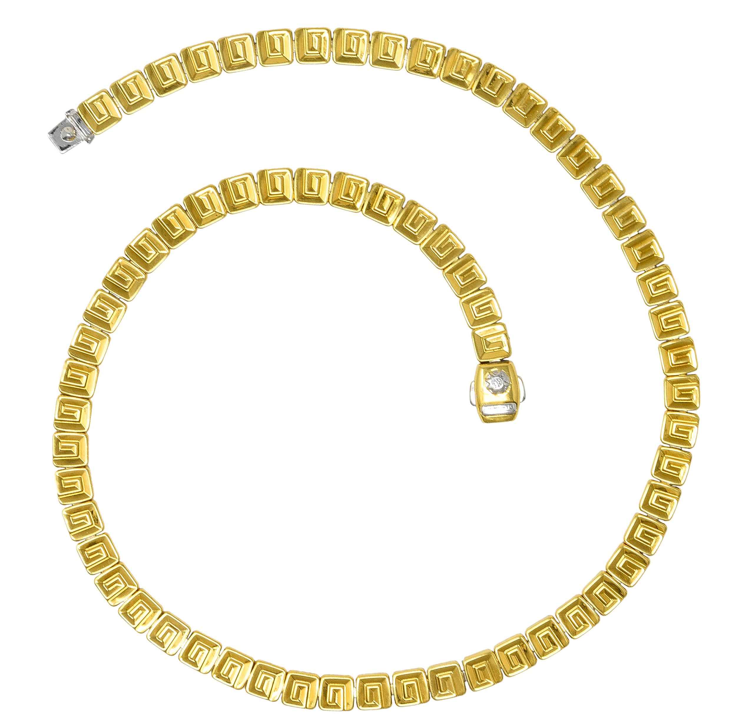 Designed as hinged square links - reversible with yellow gold on one side and white gold on the other. White gold side features an alternating pattern of linear and geometric motif links. Yellow gold side features a grooved Greek key motif. High