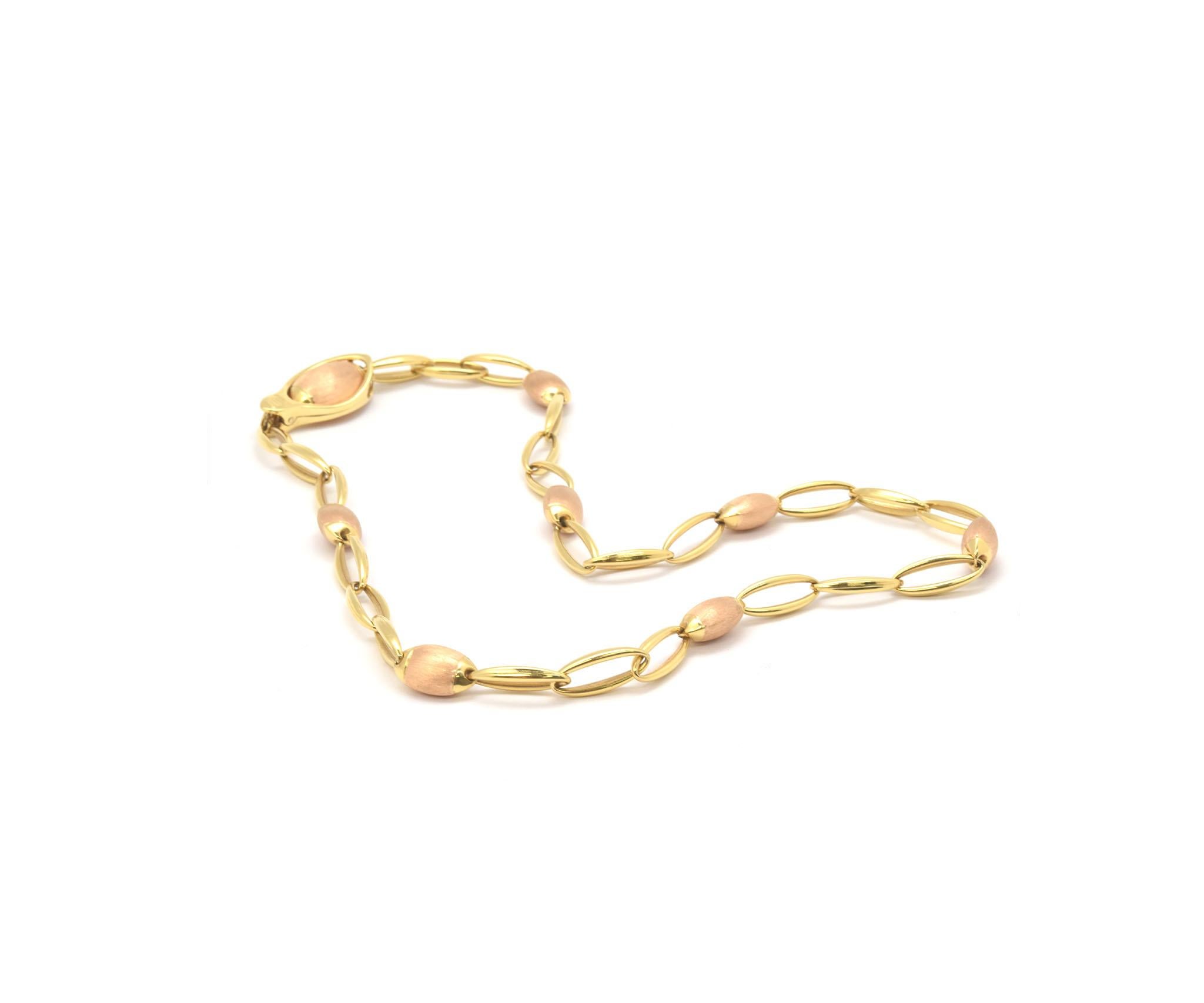 This stunning chain is made in solid 18k gold (rose and yellow) by designer Chimento. The necklace measures 22 inches in length, and it measures 17mm wide at the widest point. The necklace weighs 38.2 grams. It is signed “Chimento 750.” The necklace