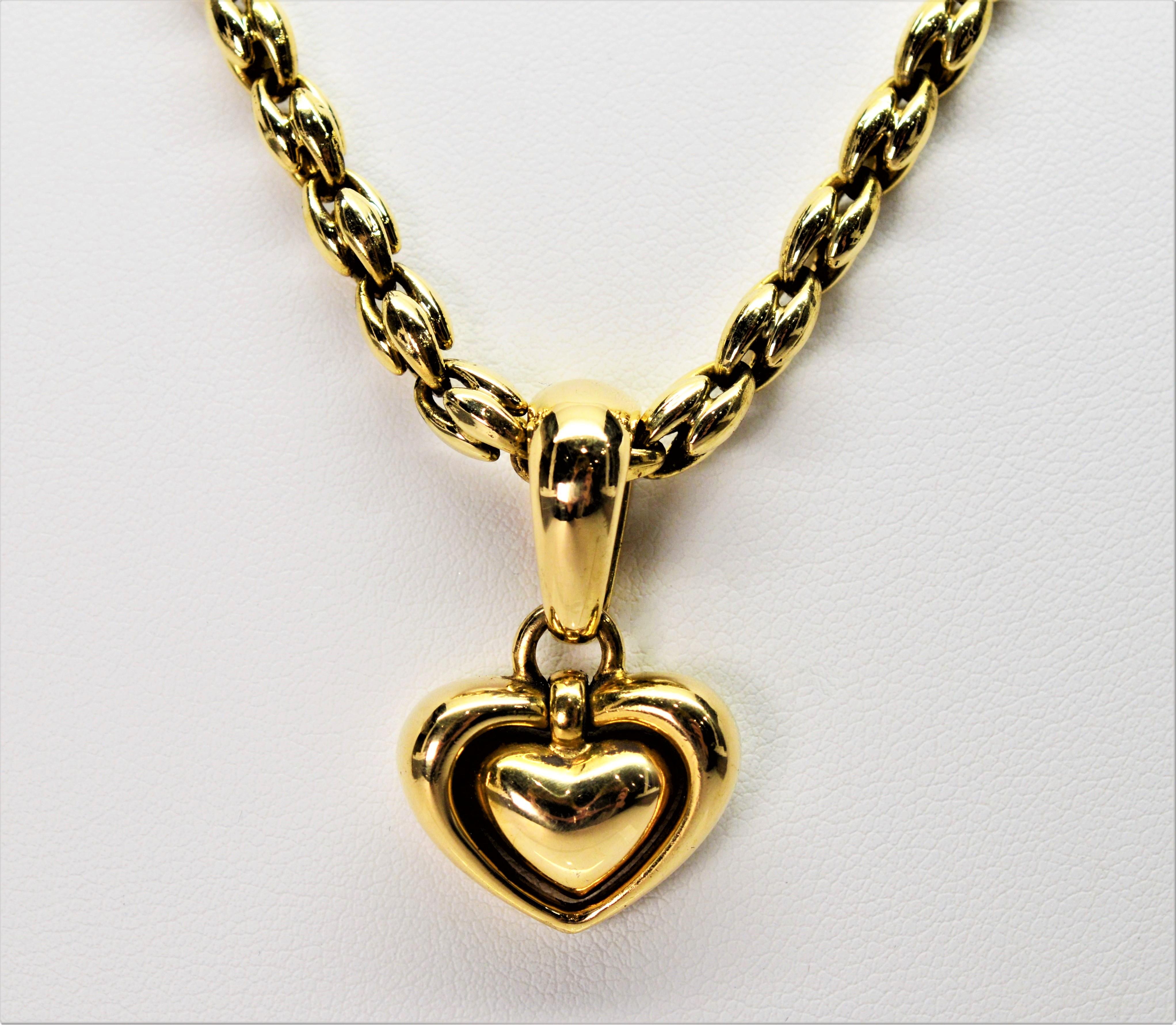 Quality Italian made by Chimento in bright eighteen karat (18K) yellow gold, this romantic pendant necklace displays a pleasingly plump double heart gold charm enhancer. The heart pendant can be removed creating a sophisticated fancy designer 5mm