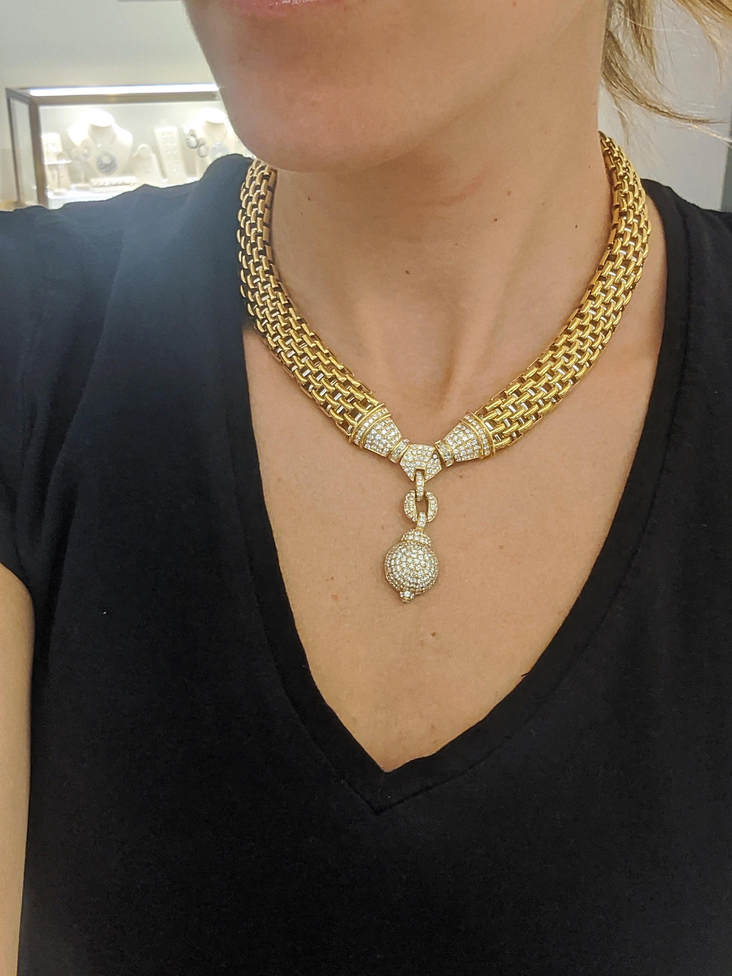 This retro styled necklace is designed with an 18 karat yellow gold link chain. The chain is designed with panthere links that are tubular with a heavy mesh feel. The necklace centers a pave diamond section with a diamond ball drop. Made in Italy by