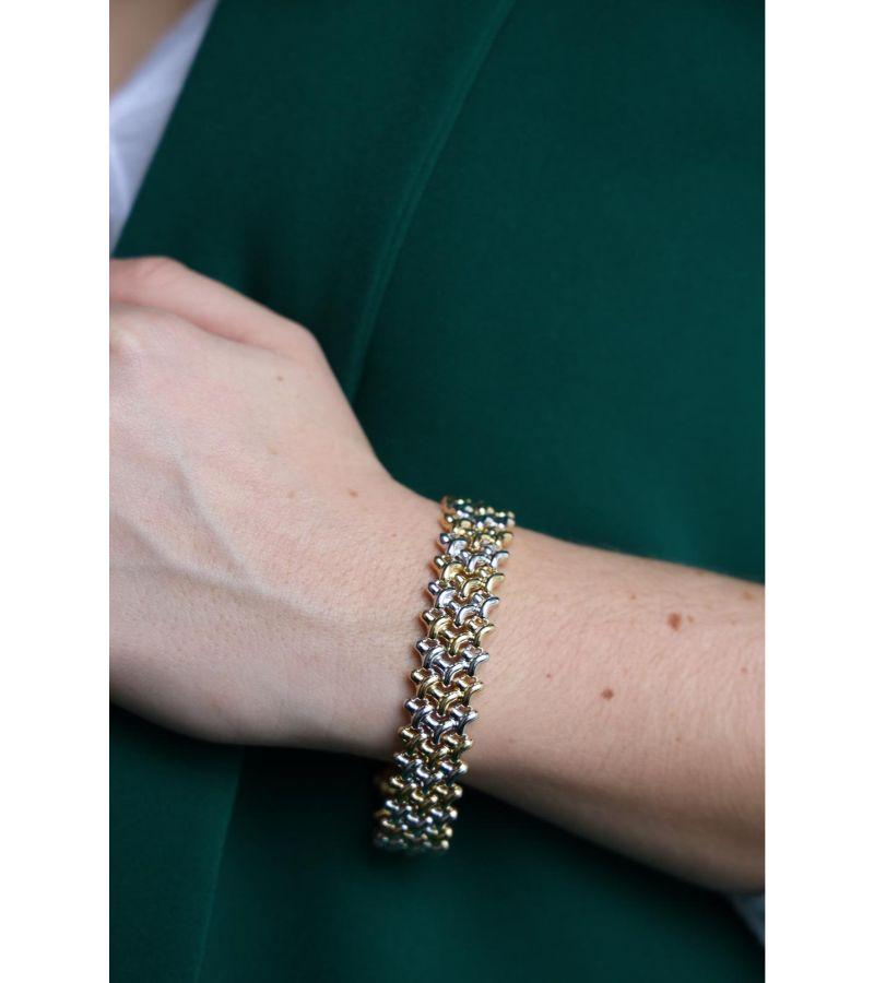 Bracelet signed by Chimento in yellow and white gold 750 thousandths (18 carats). Fancy mesh. set with a brilliant cut diamond of about 0.01 ct. Length: 19 cm. Width: 1.5 cm. Total weight: 27.03 g. Eagle head hallmark. Excellent condition
