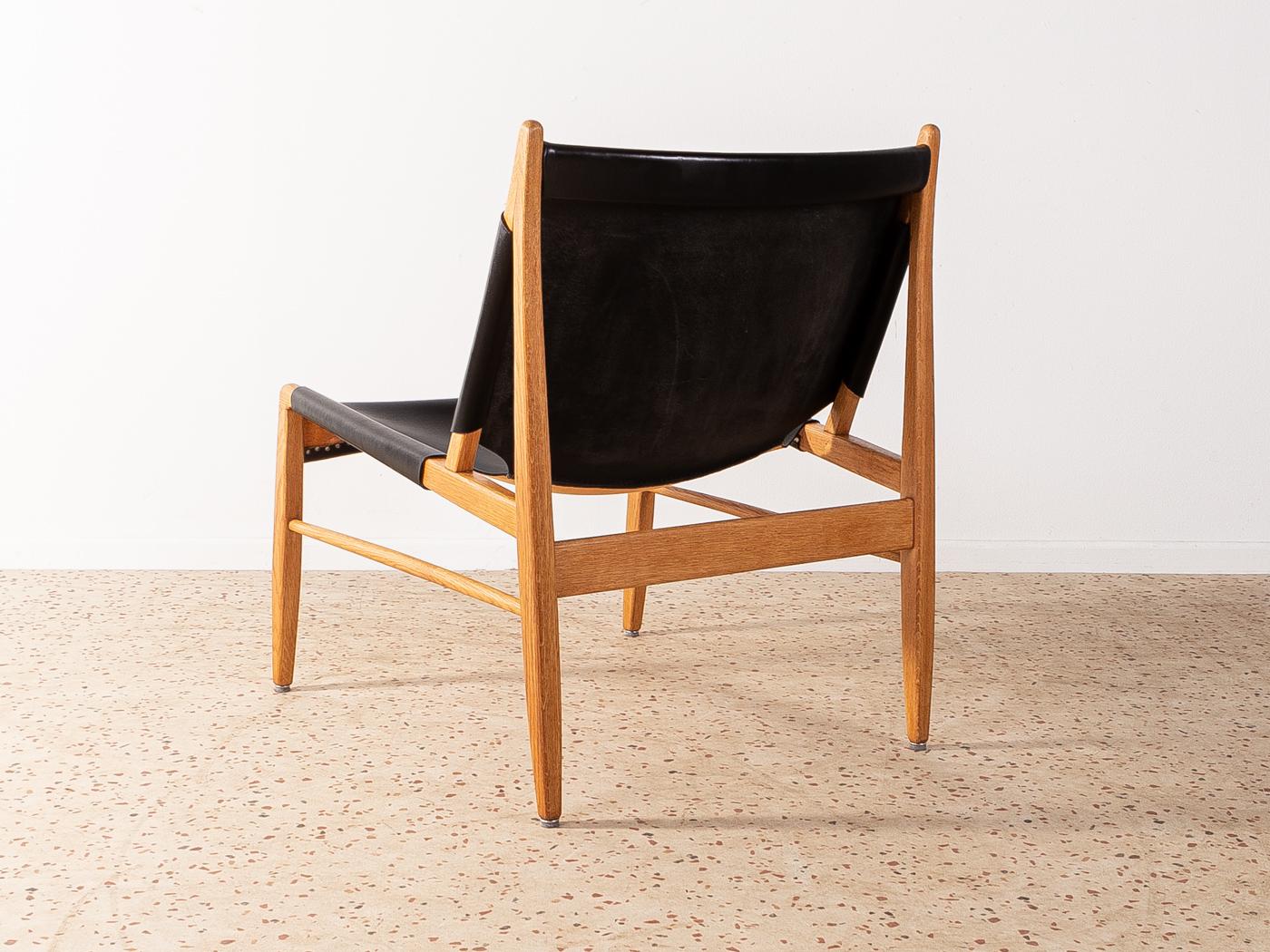 Wonderful armchair, model 1192, by Franz Xaver Lutz for WK Möbel from 1958. Solid oak frame with original leather covers in black.

Quality Features:
 accomplished design: perfect proportions and visible attention to detail
 high-quality