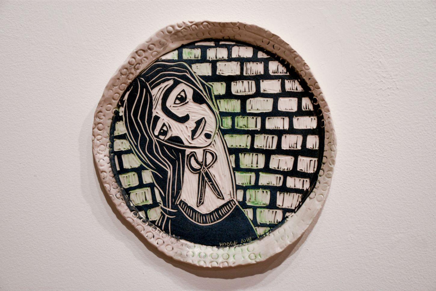 Chin Up, Portrait, 2019 by Alex Hodge
Hand carved porcelain plate 
Height: 11 in x Diameter: 11 in
Unique

Her poetic porcelain plates examine and reimagine the history of art in a way that values women, not only in body, but in wholeness, power,
