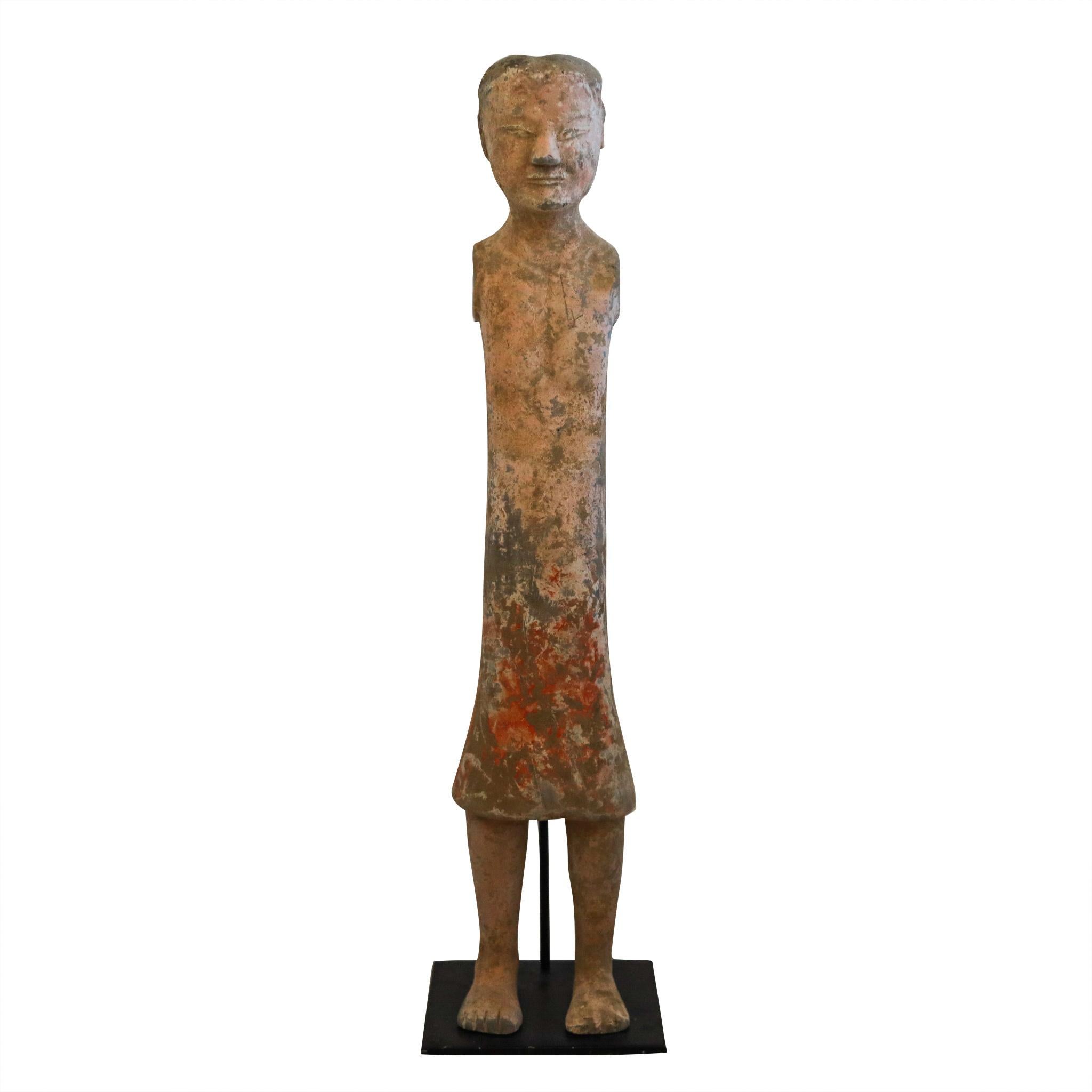 Standing Stickman from the Han Dynasty.

Original ancient Chinese tomb attendants sculpture of a tall, thin standing man wearing a short tunic. Beautifully crafted in grey earthenware terracotta around the 100 BC, during the Han dynasty period