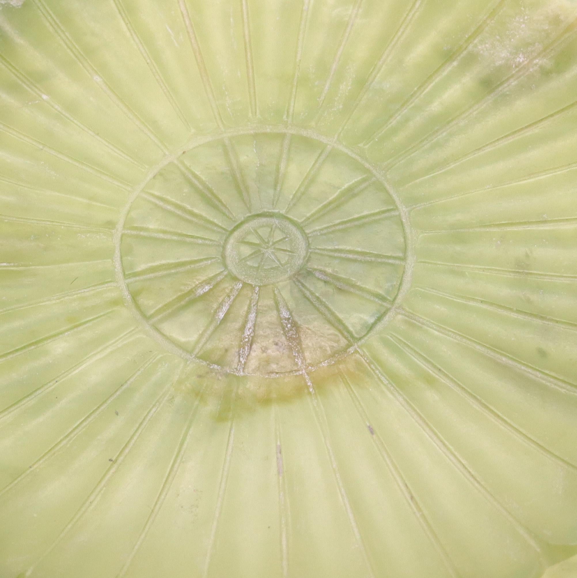 Chrysanthemum flower Jade dish from the Qing Dynasty (1644-1911).

Beautifully carved piece from the imperial China period of the Qing Dynasty. This rare dish was carved in the form of a chrysanthemum flower from a single piece of green-yellowish