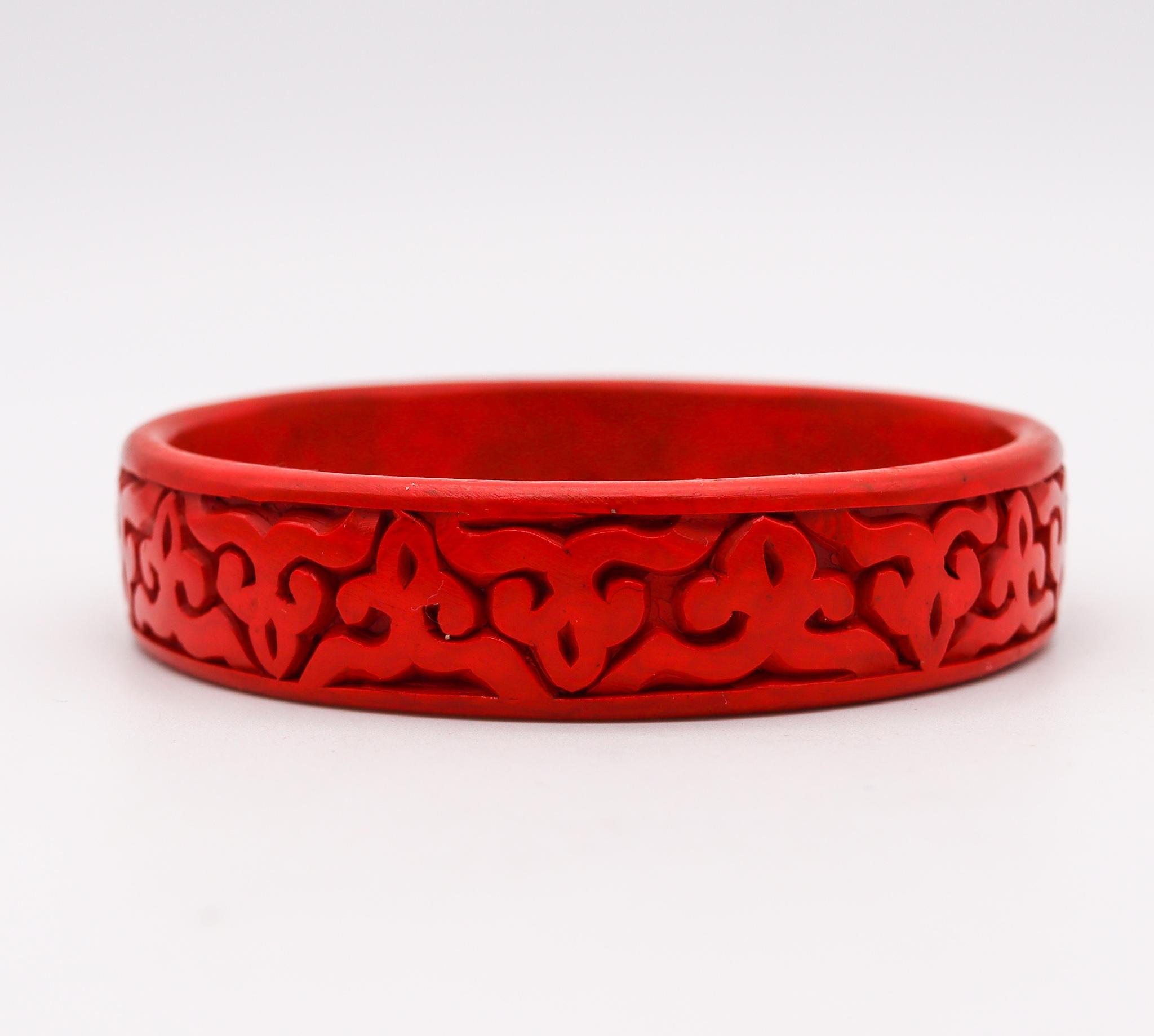 A red Cinnabar lacquer bangle bracelet.

Very nice antique Chinese export bangle bracelet, made in the late 19th century during the Victorian era (1838-1901), circa 1900. It is finely made in wood with red cinnabar lacquer and carved with geometric