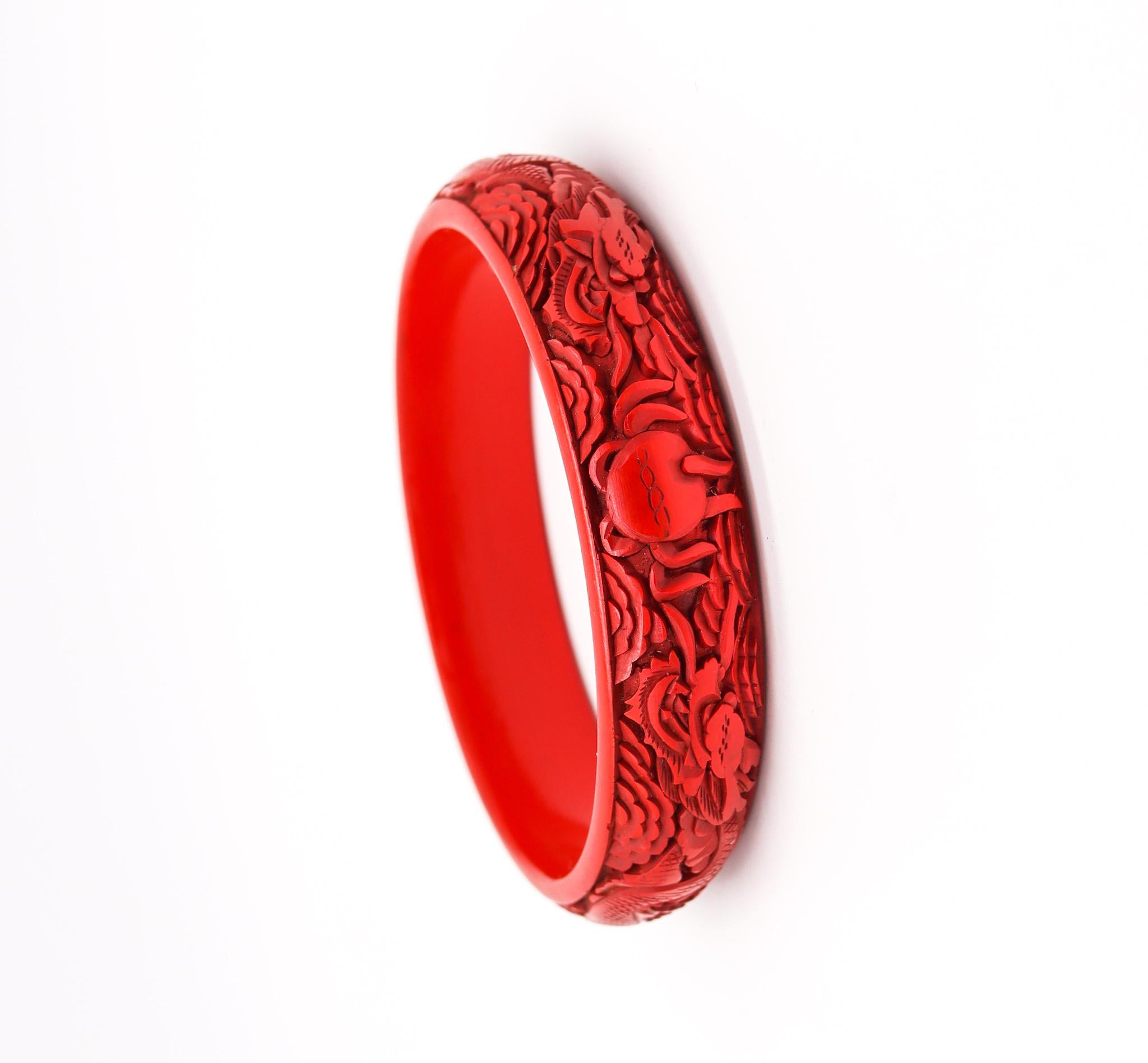 A Cinnabar lacquer bangle bracelet.

Very nice antique Chinese export bangle bracelet, made in the late 19th century during the Victorian era (1838-1901), circa 1900. It is finely carved in wood with red cinnabar lacquer and depicts the detailed
