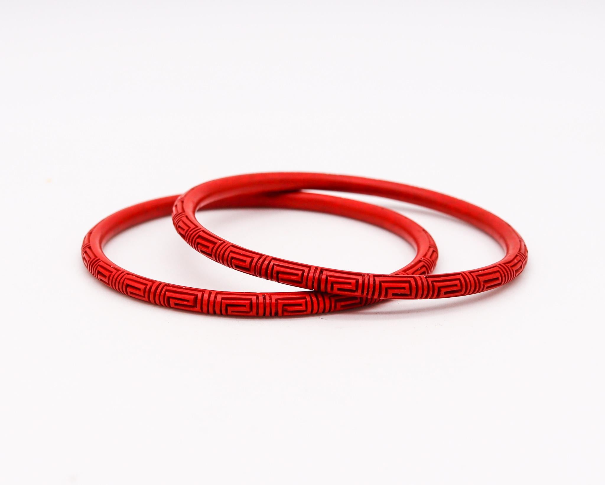 Pair of Cinnabar lacquer bangle bracelets.

Very nice antique Chinese export bangle bracelet, made in the late 19th century during the Victorian era (1838-1901), circa 1900. It is finely made in wood with red-bluish cinnabar lacquer and carved with