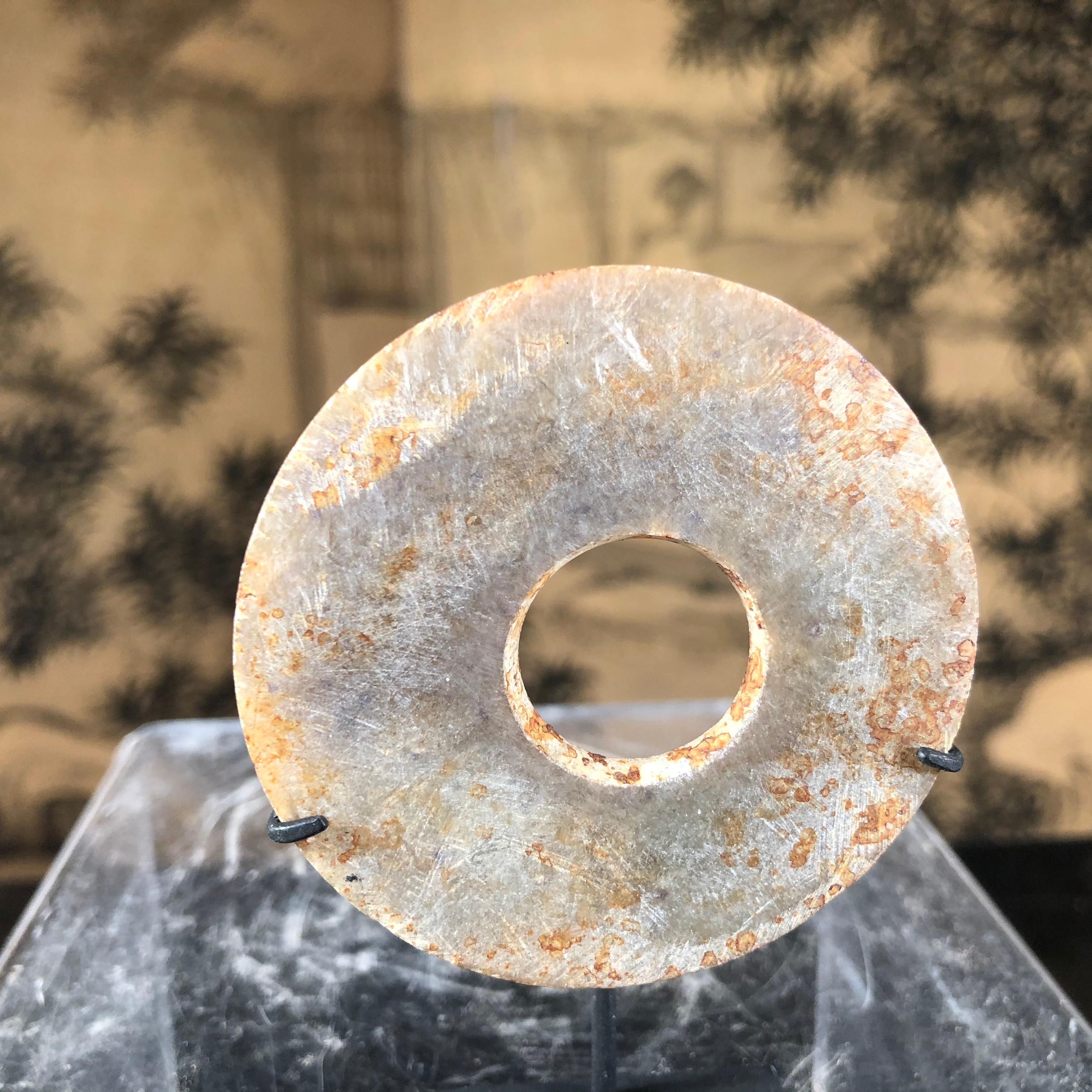 This is an authentic Chinese ancient jade bi disc from the Qi Jia Culture, Northwestern China, 3,000-2,000 BCE. This comes from our private collection. 

Including Our Certificate of Authenticity

This is a lovely example. It could also make an