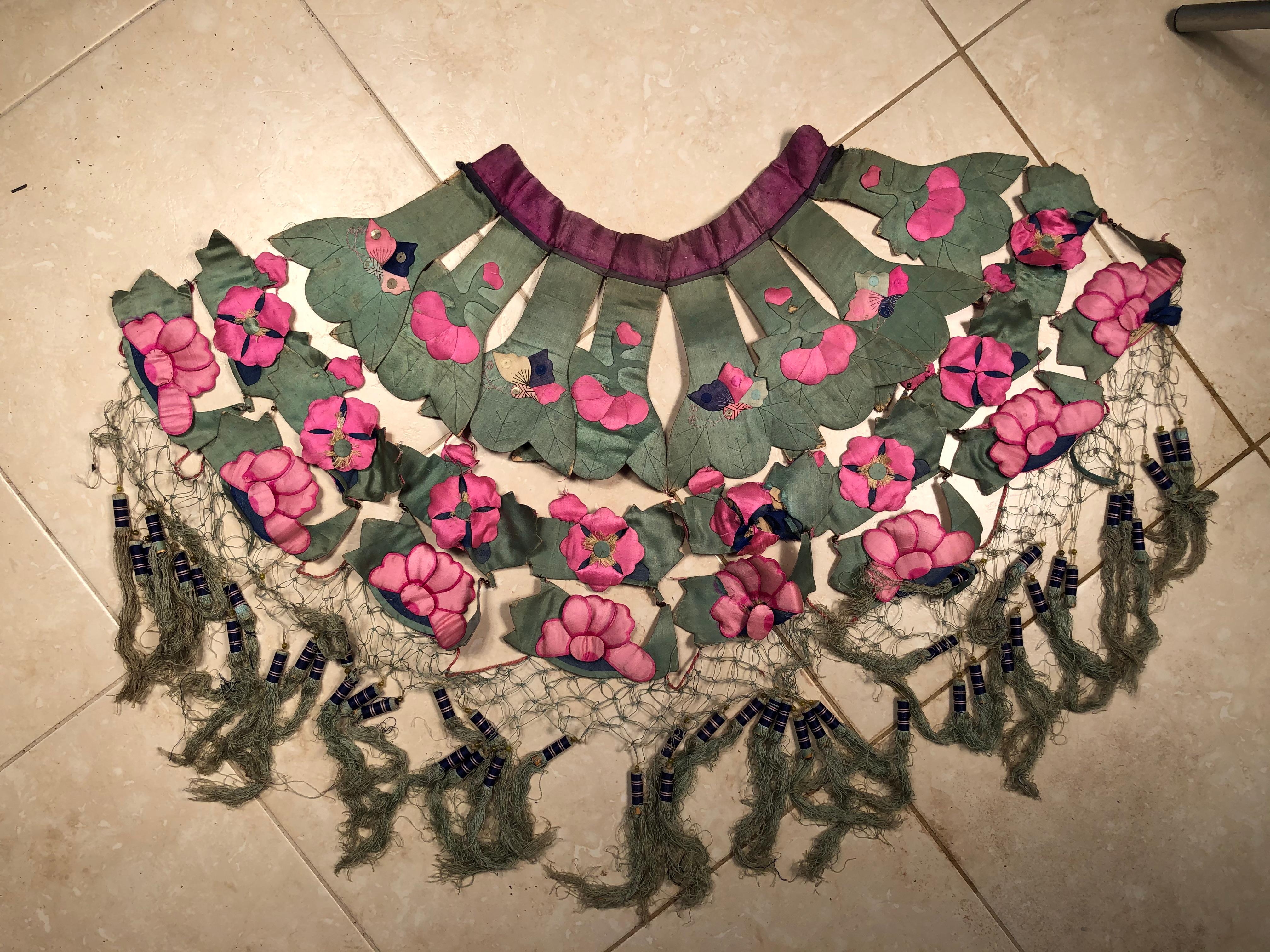 An opportunity to acquire a lovely antique Chinese hand sewn fancy collar textile pieced together in four wing like sections, all in vibrant pink and colors. 

Immediately wearable or frameable.

Dimensions: 26 inches by 36 inches tall and 3 inches