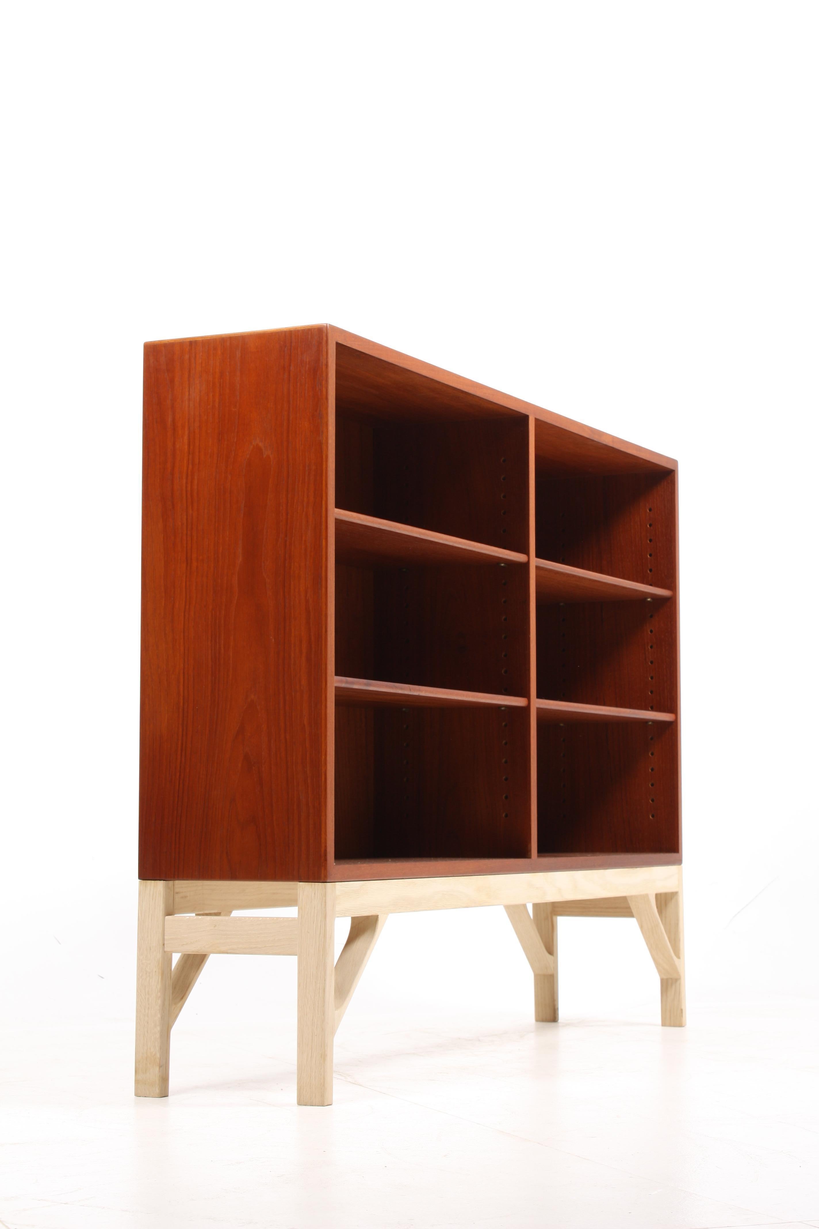 Low China bookcase in oiled teak on a soap finished oak base. Designed by MAA. Børge Mogensen in 1958, this piece is made by CM Madsen cabinetmakers Denmark in the 1960s. Great original condition.