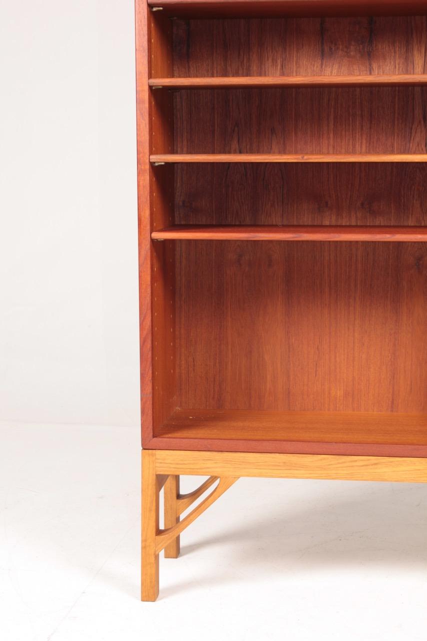 Bookcase in oiled teak on a solid oak base. Designed by MAA. Børge Mogensen in 1958, this piece is made by CM Madsen cabinetmakers Denmark in the 1960s. Great original condition.