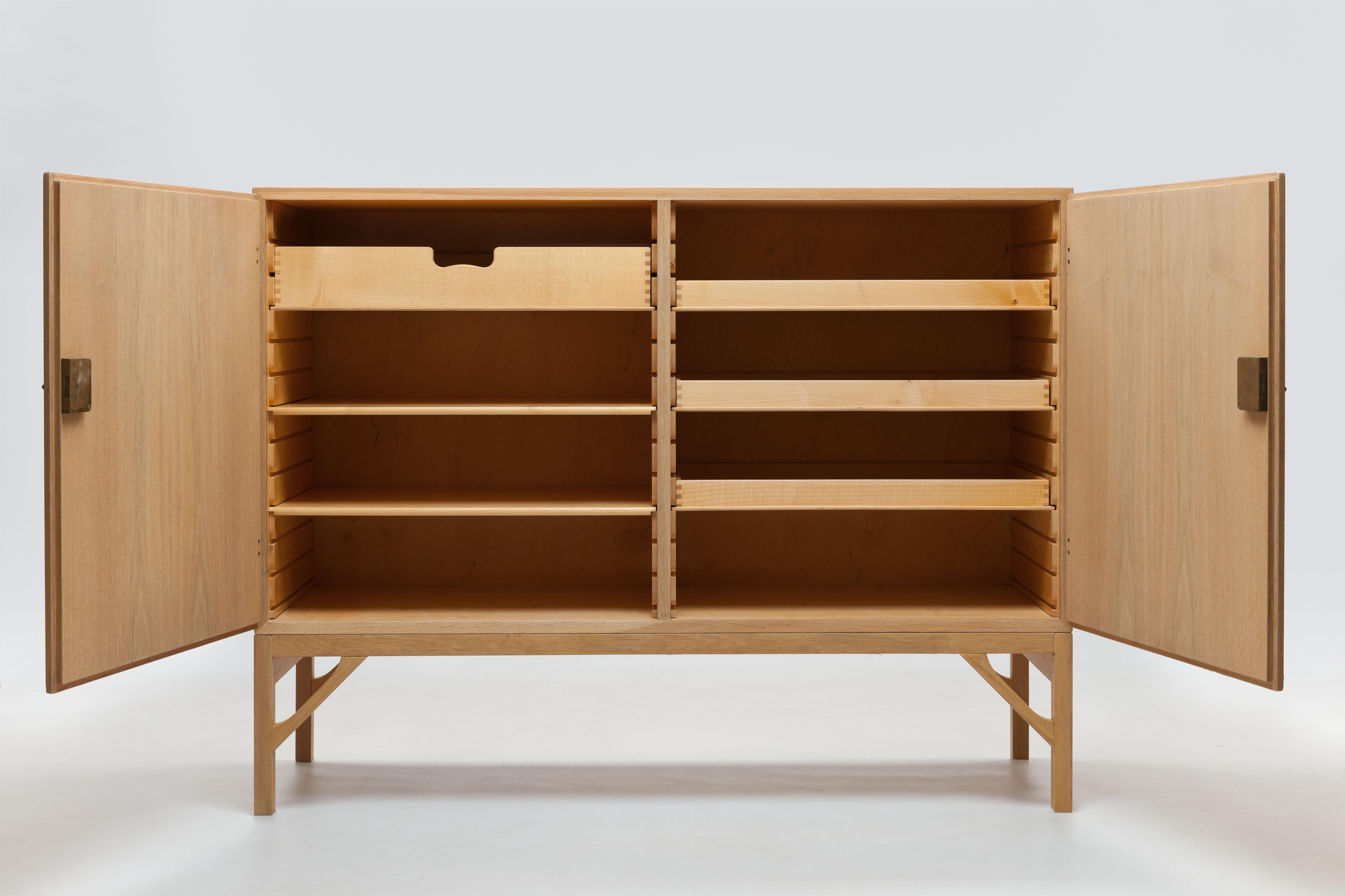 Oak cabinet model A232 designed in 1958 by the Danish designer Borge Mogensen for FDB Møbler, made by CM Madsen, Denmark. 
This clean design is executed in wonderful quality with attention to every detail. The cabinet is finished with solid oak
