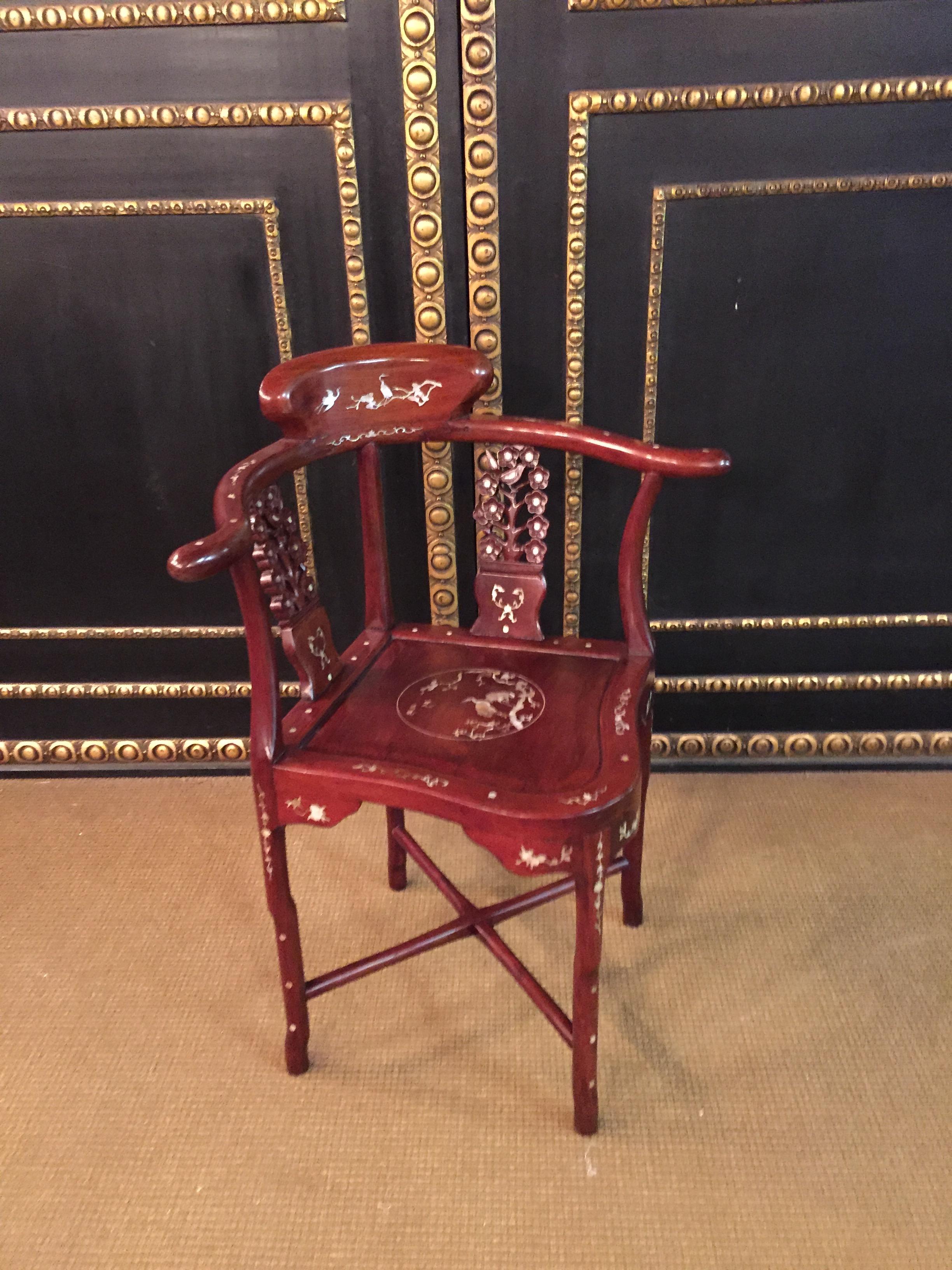 Beautiful chair with a fantastic mother of pearl inlays.

Solid tropical wood.