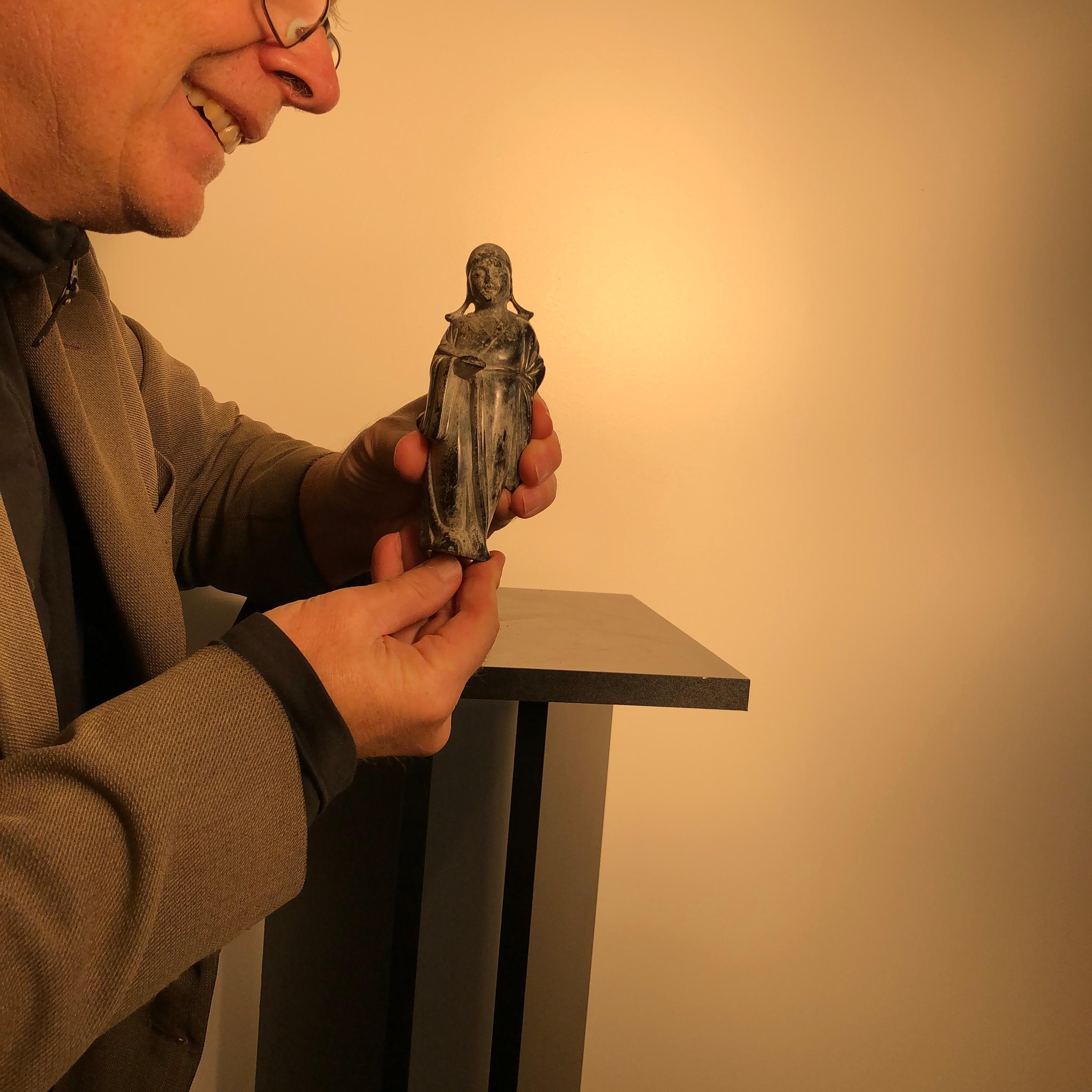 China, a fine early jade of a scholar in a Ming style robe- holding a fan in his lower right hand, a significant jade ornament hand carved in a dark green colored jade with original and substantial patina from hundreds of years of age.

Unique