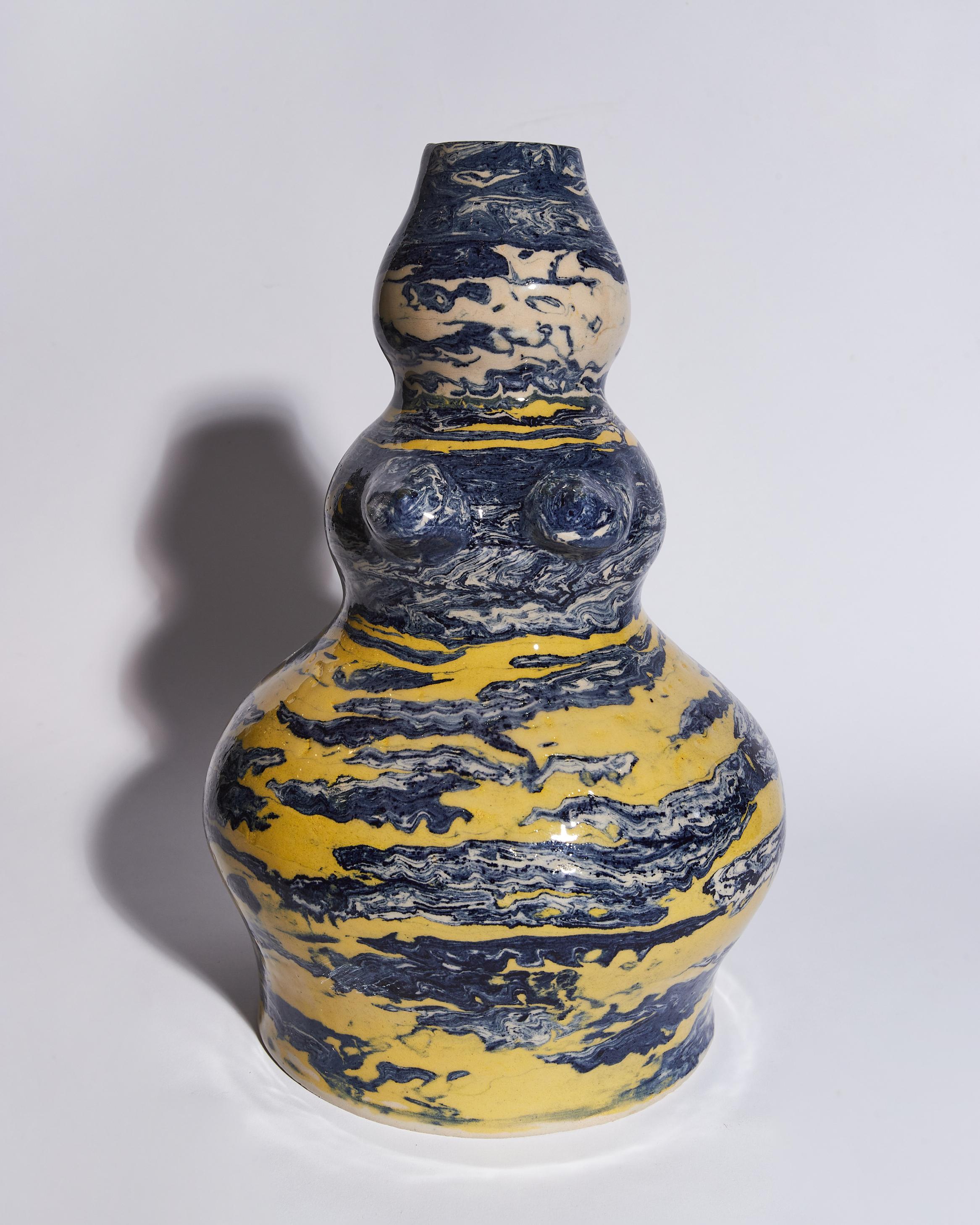 This piece is 100% handcrafted . The use of Cobalt oxide and yellow stain gives an Asian aesthetic to the vase . 
My inspiration comes from the ancient anatomical votive offerings. These were clay body parts that the ancient Greeks offered to the