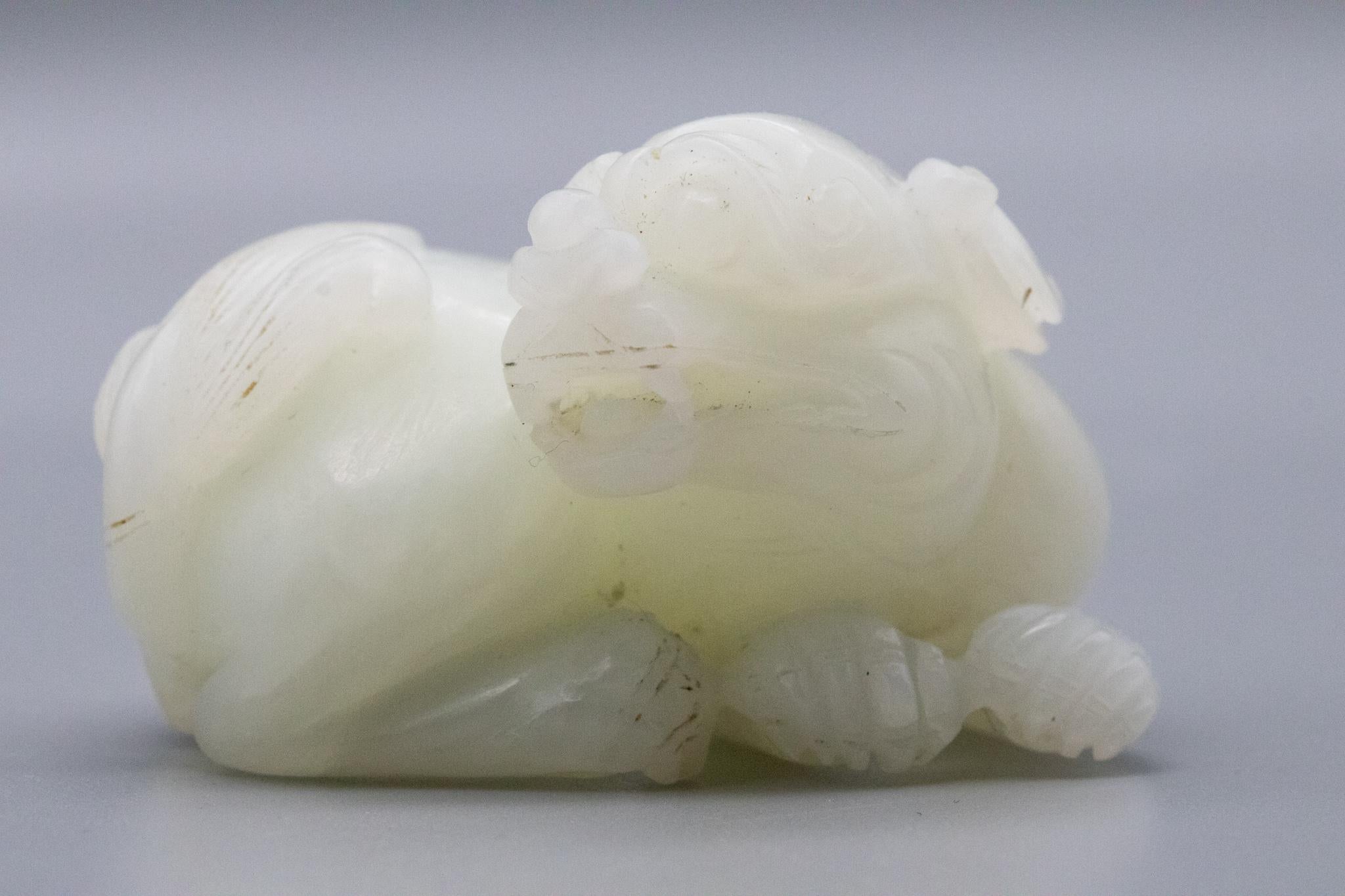 China Qing Dynasty 18th Century Reclining Foo Dog Carved in White Nephrite Jade In Excellent Condition In Miami, FL