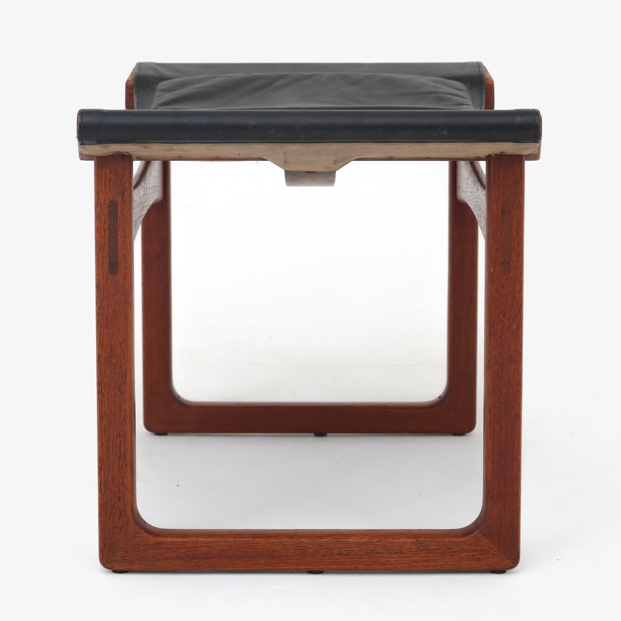 'China Stool' in solid teak with patinated black leather. Designed in 1951. Maker Ludvig Pontoppidan.