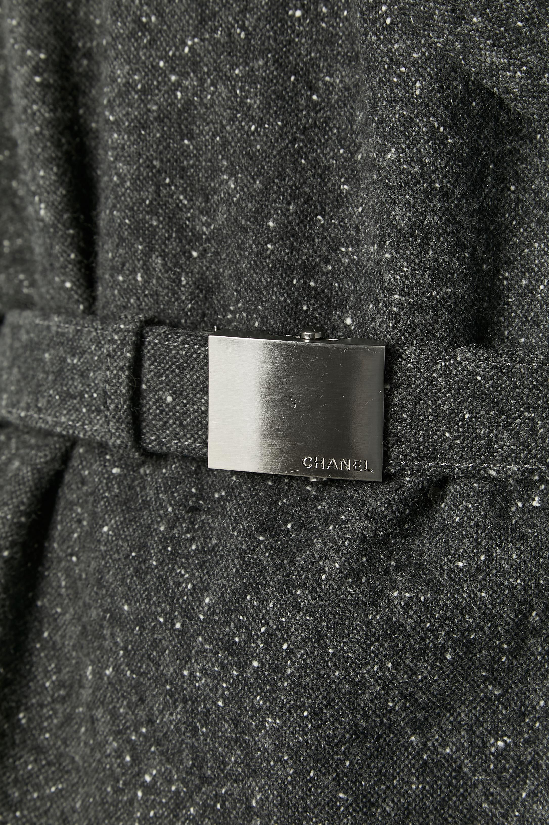 Chiné grey cashmere wrap jacket and skirt ensemble. Belt with metal buckle and belt-loop.  Branded button closure on the left side of the jacket. Pocket on both side. 
SIZE OF THE JACKET: 40/ L
SIZE OF THE SKIRT : 38 / M 