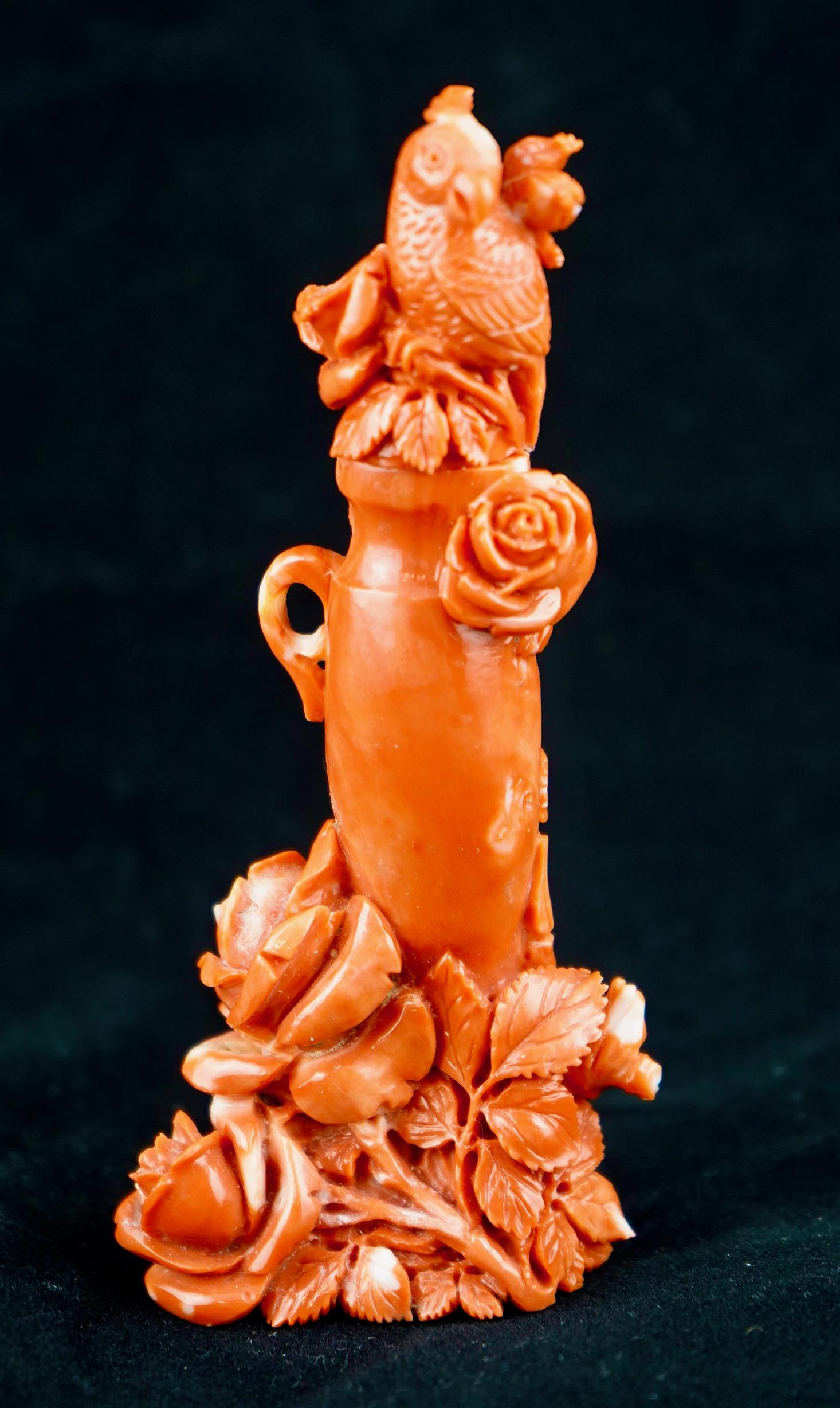 Chinese carved coral perfume bottle in a form of a covered vase with a parrot on the finial and floral decoration at the base. Very fine work with good subject matter. Weight
77 g.