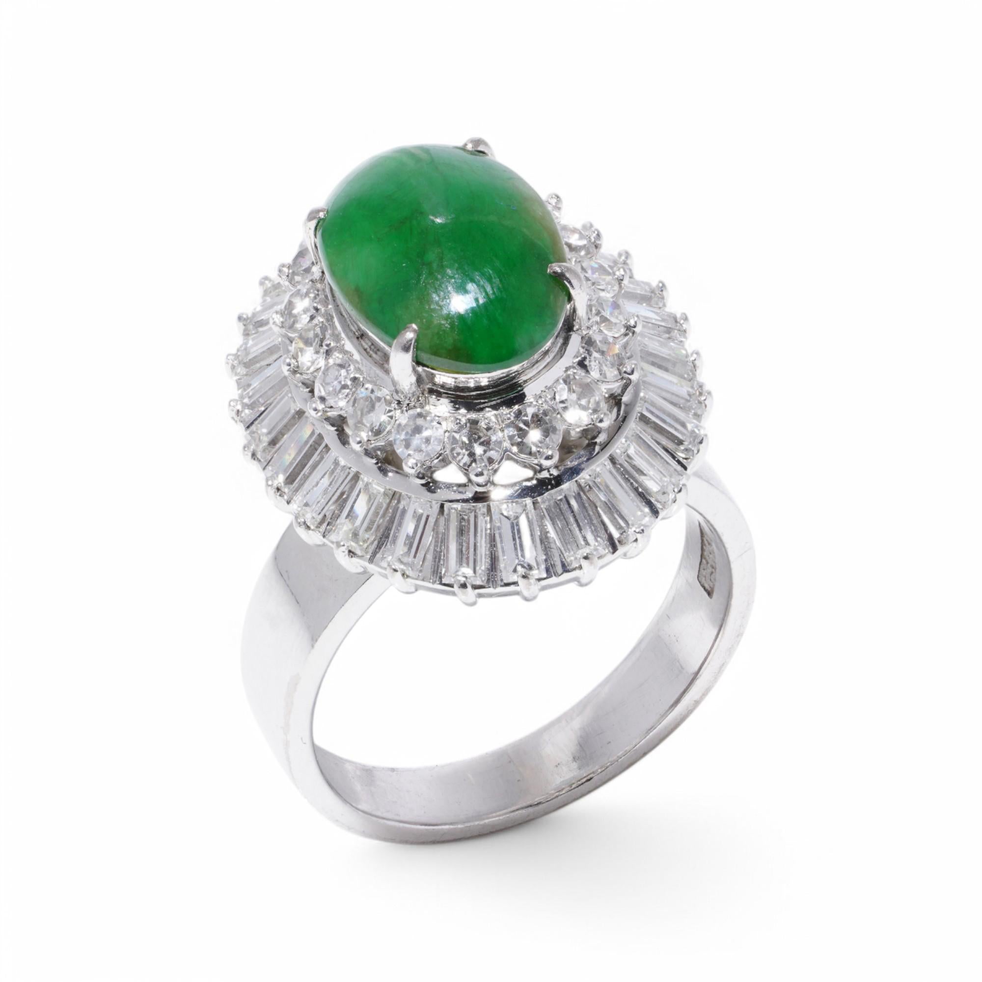 A striking Chinese 18kt white gold cluster ring, featuring a vibrant natural jade cabochon, framed by a dazzling array of baguette and brilliant-cut diamonds.
The elegant setting enhances the rich green hue of the jade, creating a bold yet timeless
