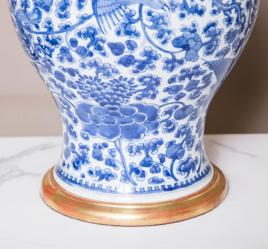 An 18th century (1736-95) Chinese blue and white porcelain phoenix vase. of high quality. Now lamped and fitted with a hand-gilded turned base and antiqued brass cap. Qianlong period.