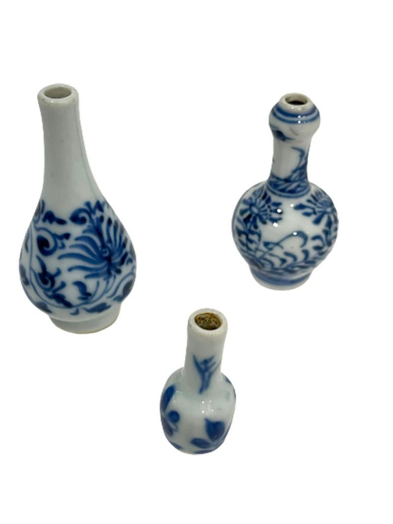 Chinese 18th century miniature porcelain blue and white Kangxi vases
Kangxi, (1662-1722)

With a scene of floral decor and 3 different shapes 
The miniature vases shows some age wear, see the details in the pictures

The measurements are 5,7