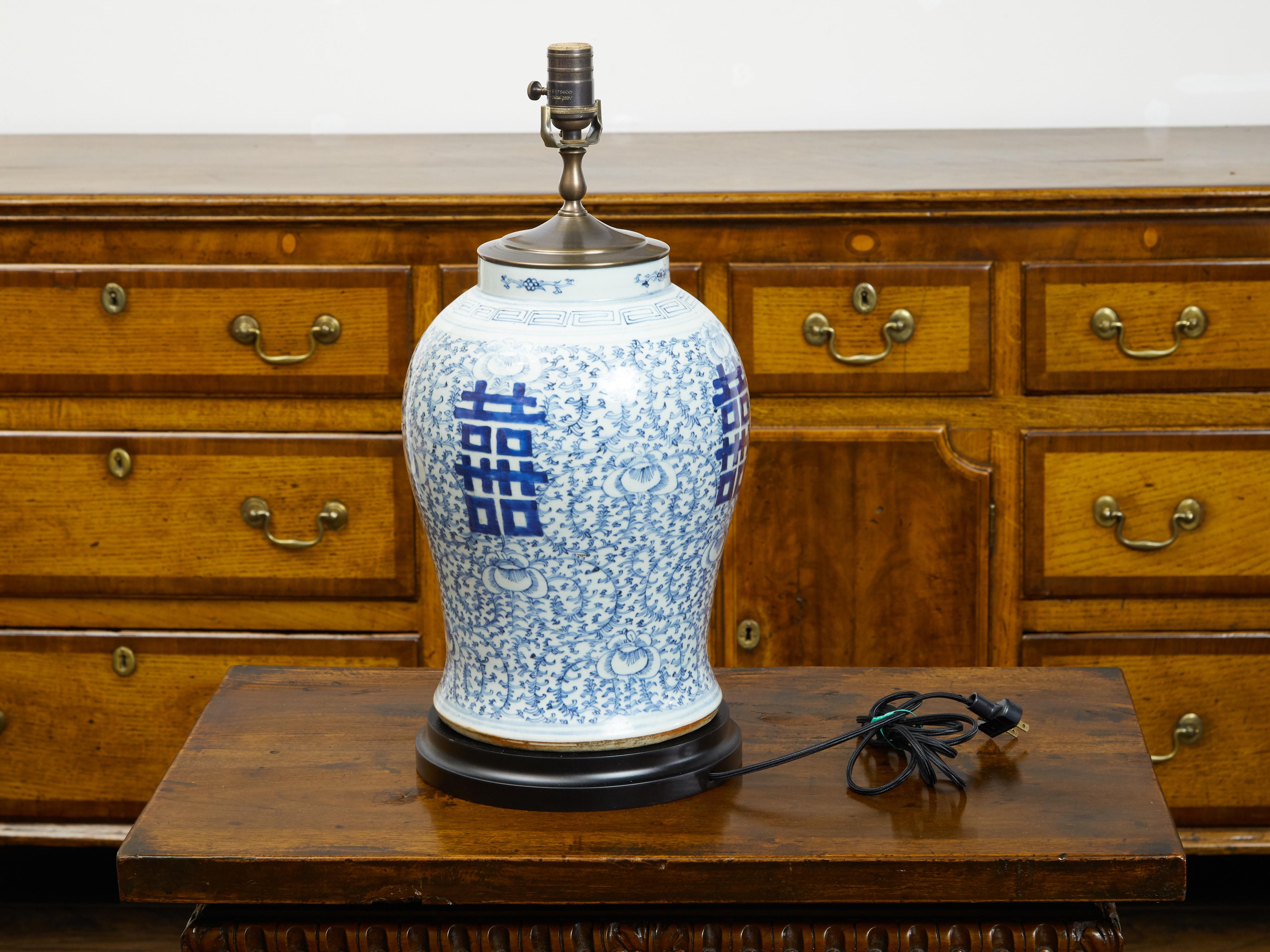 A Chinese blue and white Double Happiness temple jar from the early 20th century, mounted as a table lamp. Created in China during the first quarter of the 20th century, this temple jar features the Double Happiness motif standing out beautifully on