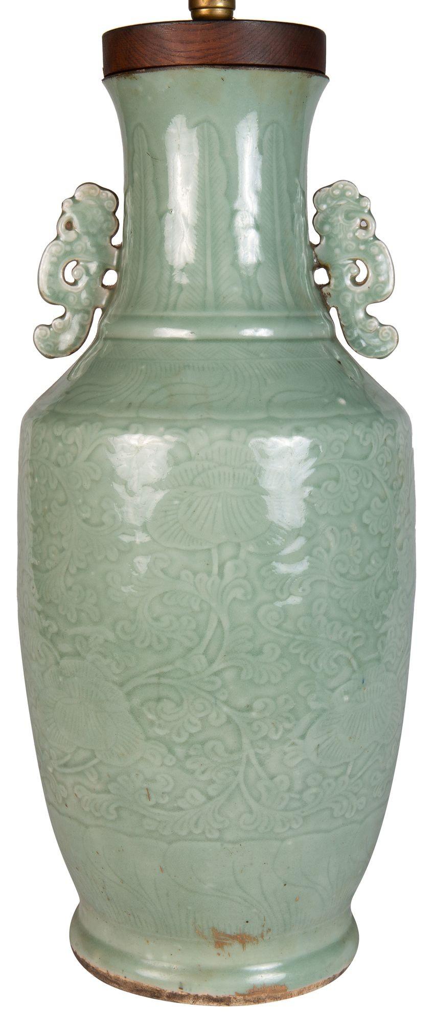 A very impressive early 19th Century, Chinese Celadon porcelain vase/lamp. Having wonderful scrolling embossed decoration to the whole and classical handles to either side.
We can have the vase mounted in a turned gilded wooden stand and rewired as