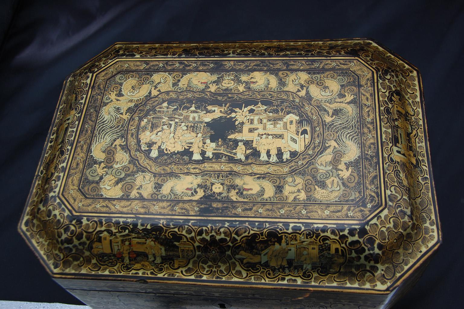 This Chinese Export early 19th century chinoiserie decorated lacquered teacaddy retains its original pair of interior pewter hand engraved double lidded tea boxes. The tea boxes have an engraved exterior lid and a plain interior lid with wooden