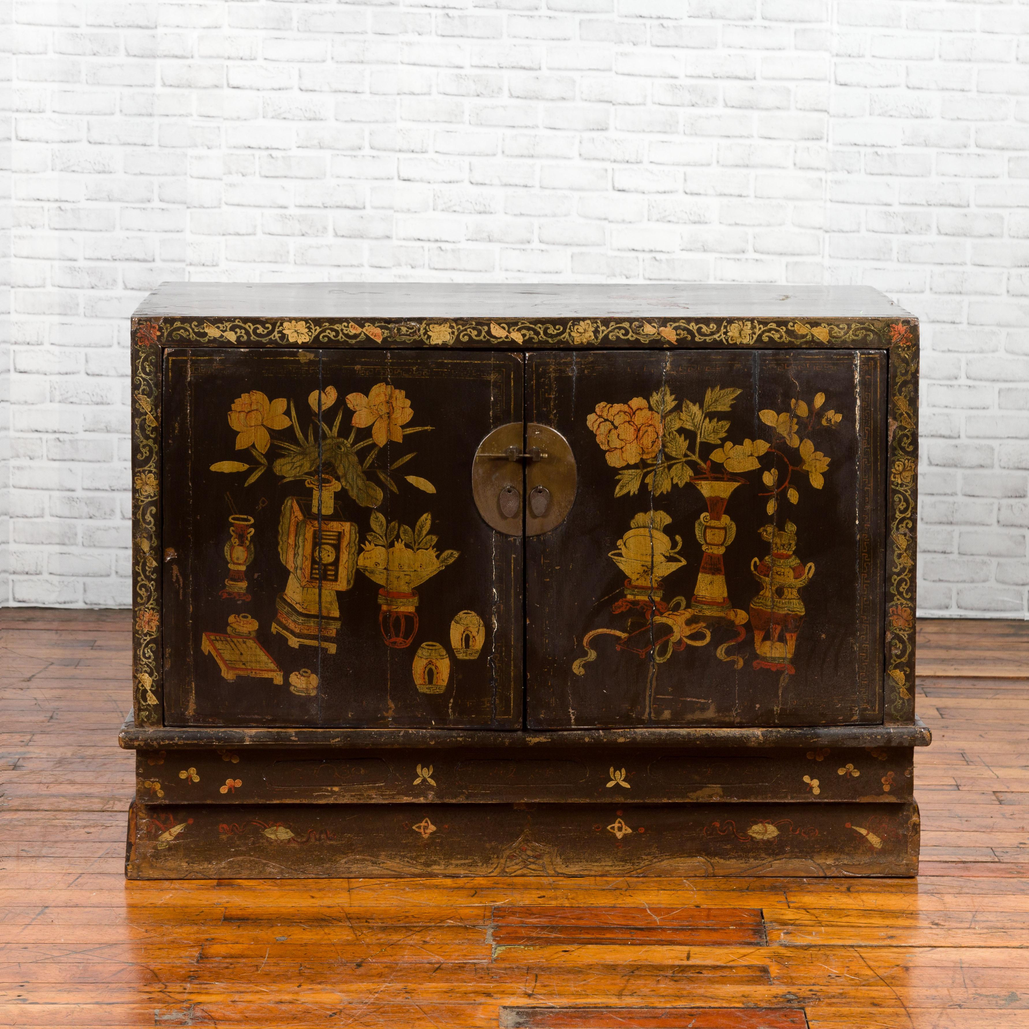 A Chinese dark brown lacquered sideboard from the 19th century, with hand painted motifs. Created in China during the 19th century, this brown lacquered sideboard features a distressed rectangular top sitting above two doors, adorned with hand