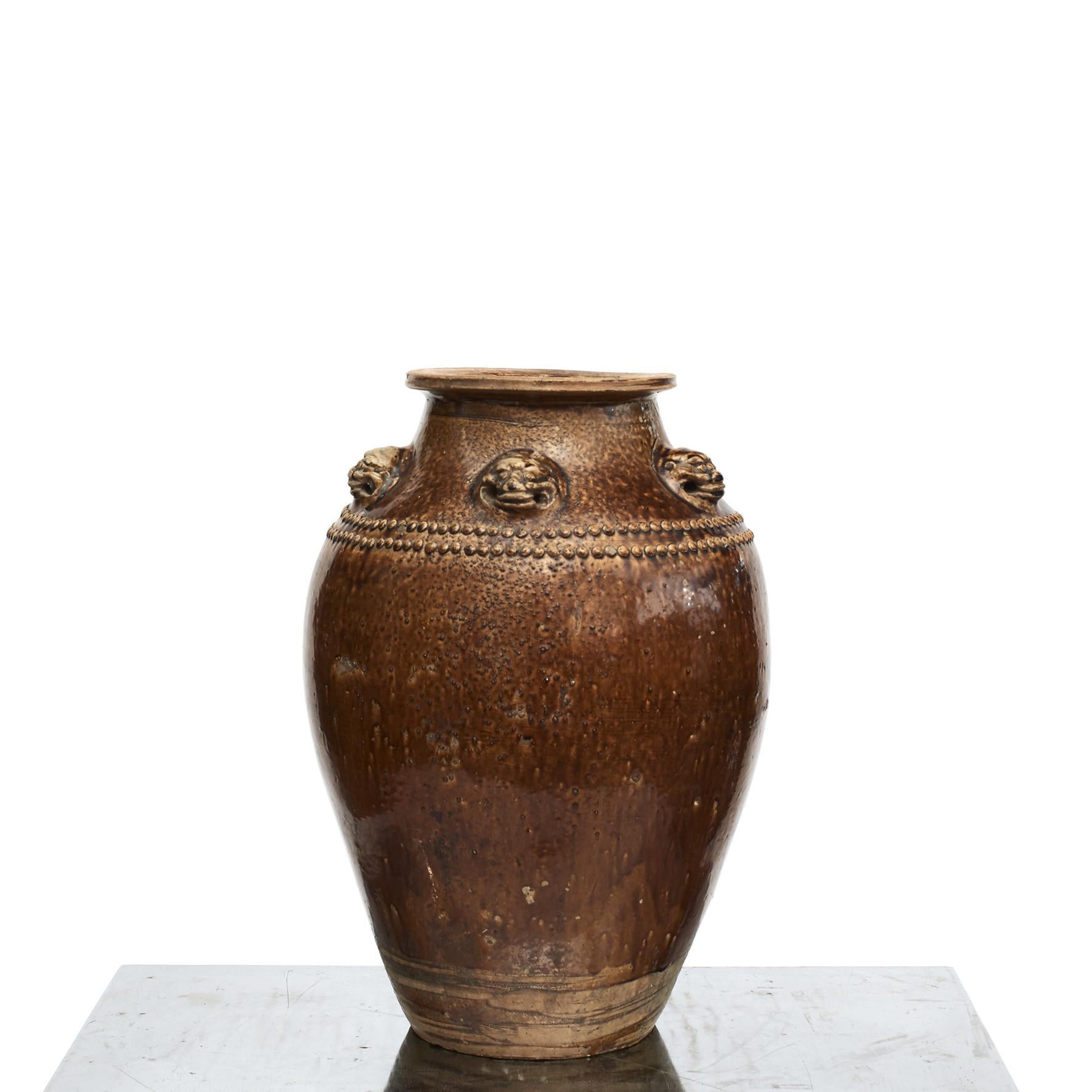 A fine and large Chinese brown ochre glazed stoneware storage jar, commonly known as a Martaban or Martavan jar.
Shoulders decorated with pearls and five lion heads molded in relief,
China, mid-19th century.
A beautiful and fascinating example of