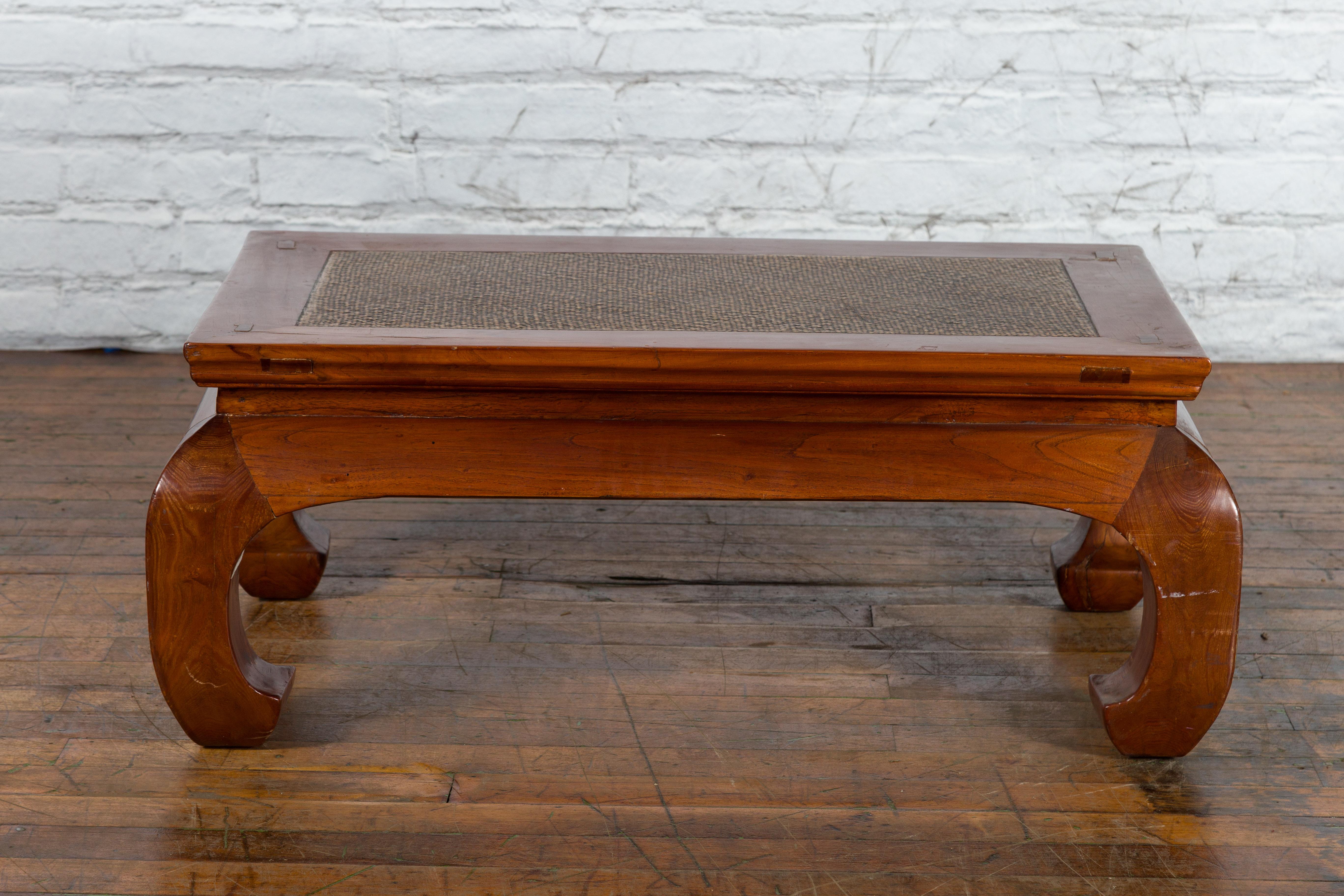 An antique Chinese Qing Dynasty period wooden brown coffee table from the 19th century, with woven rattan top and chow legs. Created in China during the Qing Dynasty in the 19th century, this brown wood coffee table features a rectangular top with