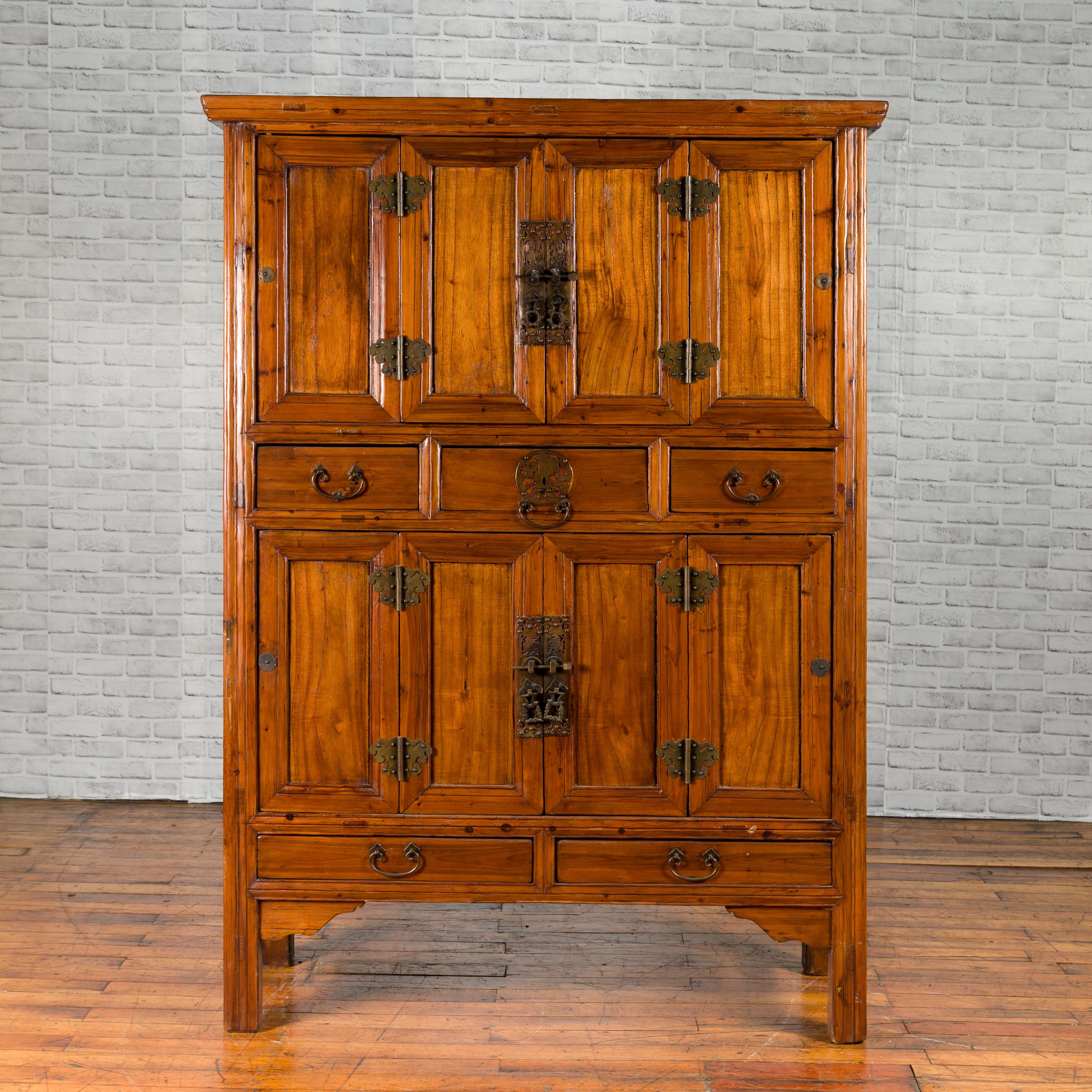 A Chinese Qing Dynasty period accordion doors cabinet from the 19th century, with five drawers. Created in China during the Qing Dynasty, this wooden cabinet features two pairs of accordion doors arranged on two levels and opening to reveal inner