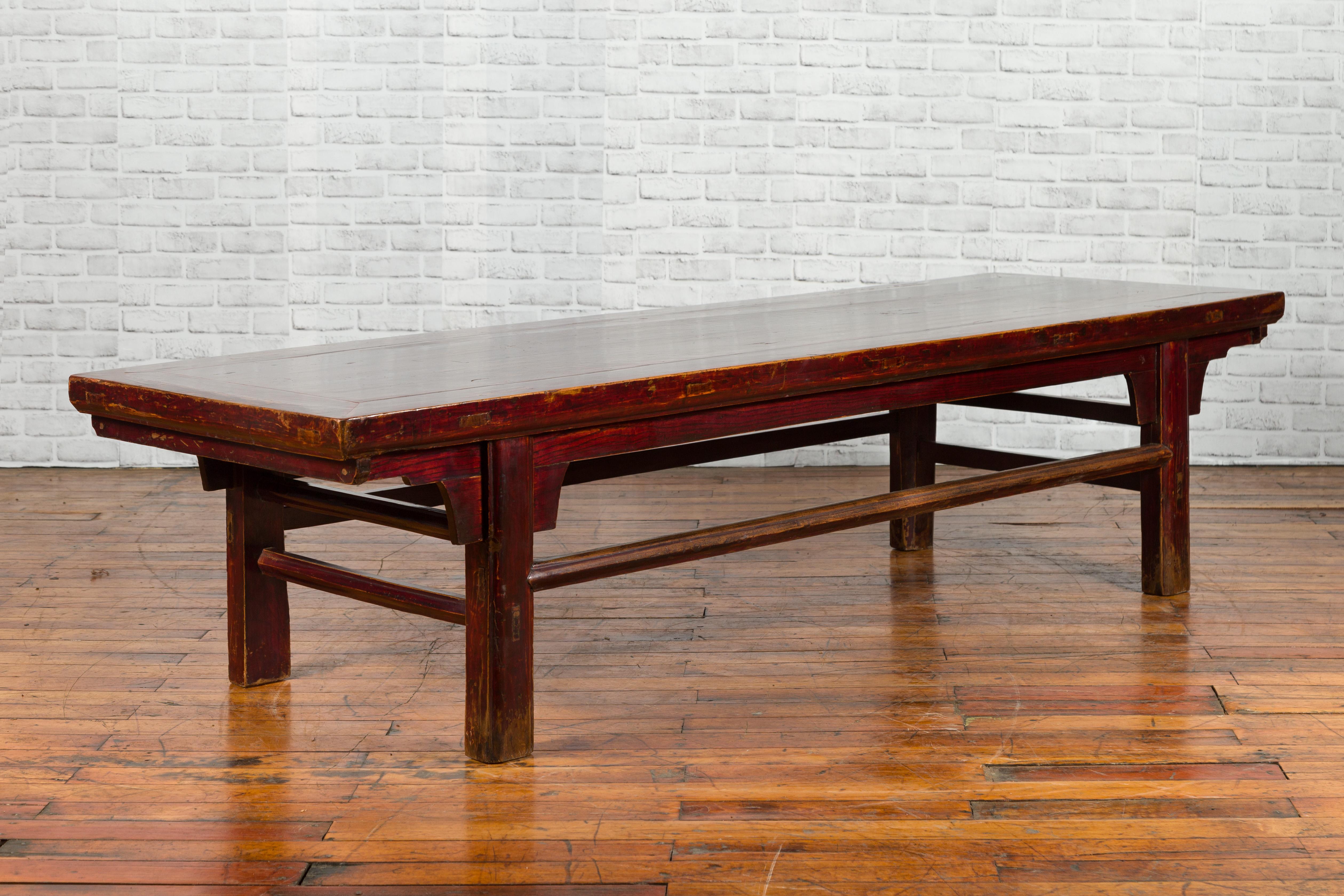 Table laquée de la dynastie Qing, datant du 19e siècle, avec une patine d'usage joliment altérée. Créée en Chine au cours du XIXe siècle, cette table laquée brun-rouge foncé de la dynastie Qing séduit par sa patine gracieusement vieillie et son