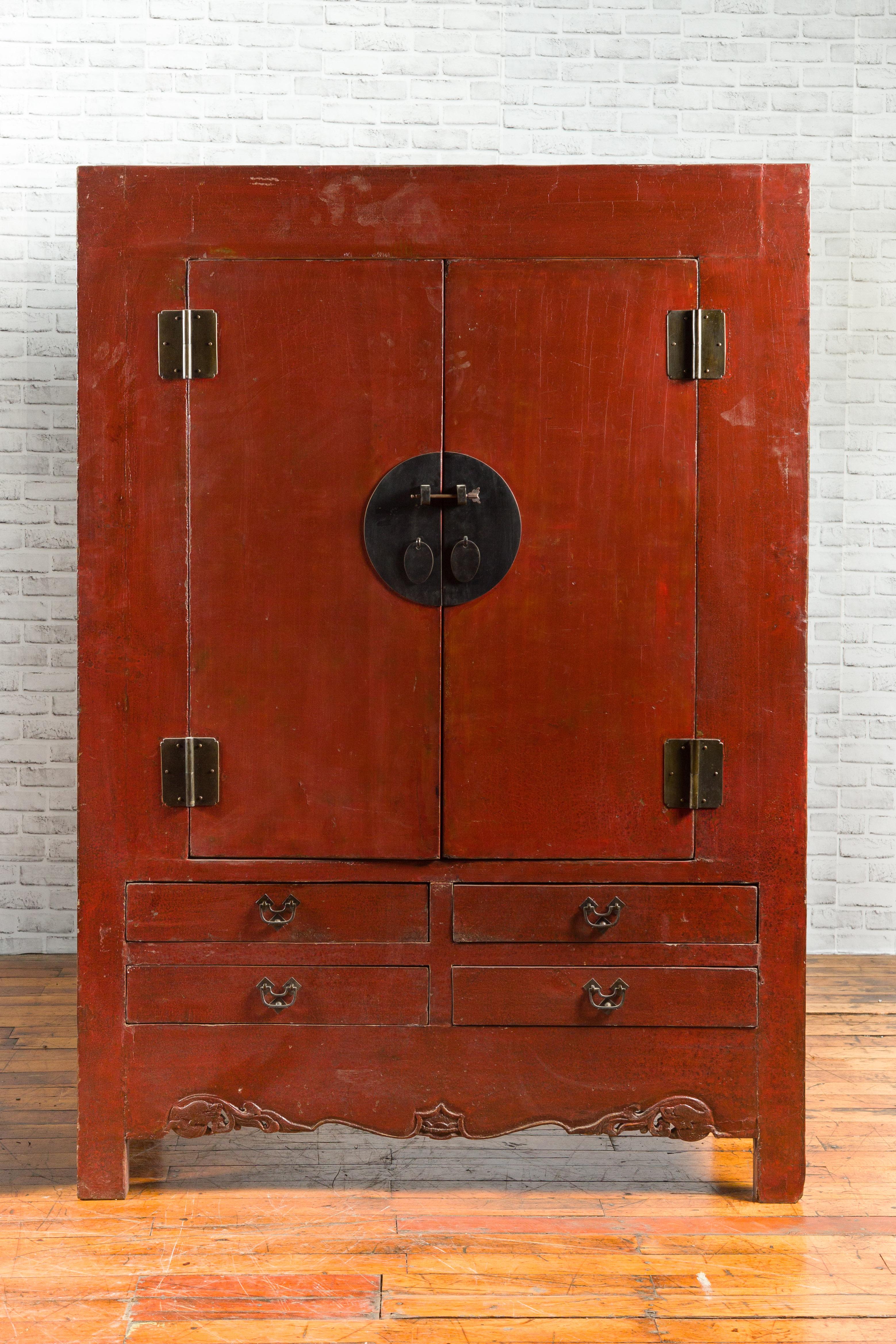 A Chinese Qing Dynasty period red lacquered cabinet from the 19th century, with round medallion hardware and drawers. We have a pair available should you need it (see image 3 for instance), however each cabinet is priced $5,500. Created in China