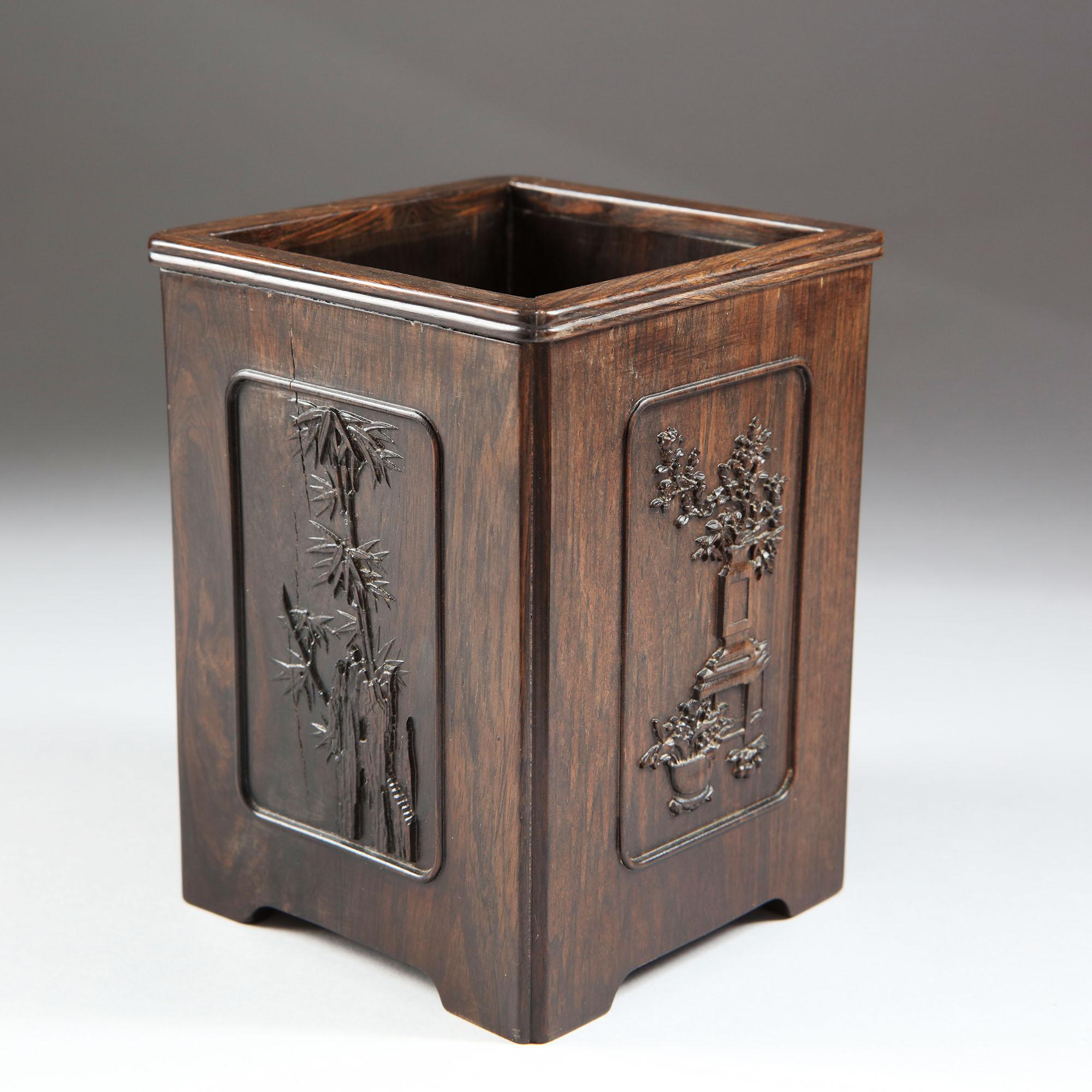 Huanghuali brush pot,
Qing dynasty, 19th century
of square form with high relief carved sides, the base having four short integral feet.

Dimensions approximate.